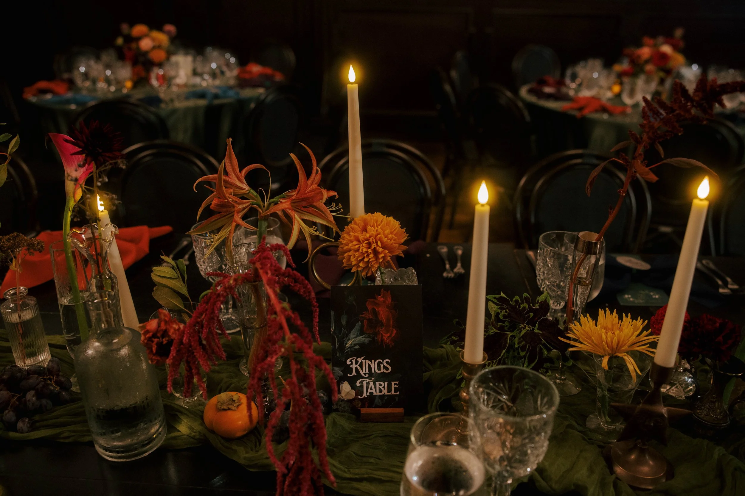 close up of the kings table with candlelight, fruit, and flowers