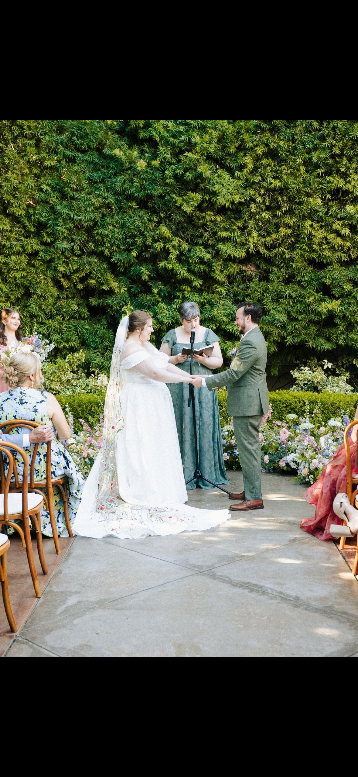 Wedding ceremony at Franciscan Gardens with a wildflower ground arch