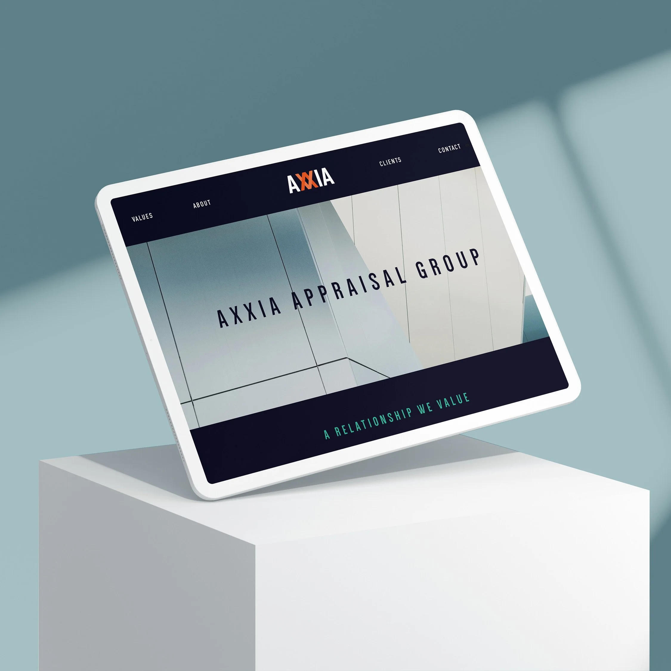 A tablet displaying Axxia Appraisal Group website on a white pedestal with a blue background.