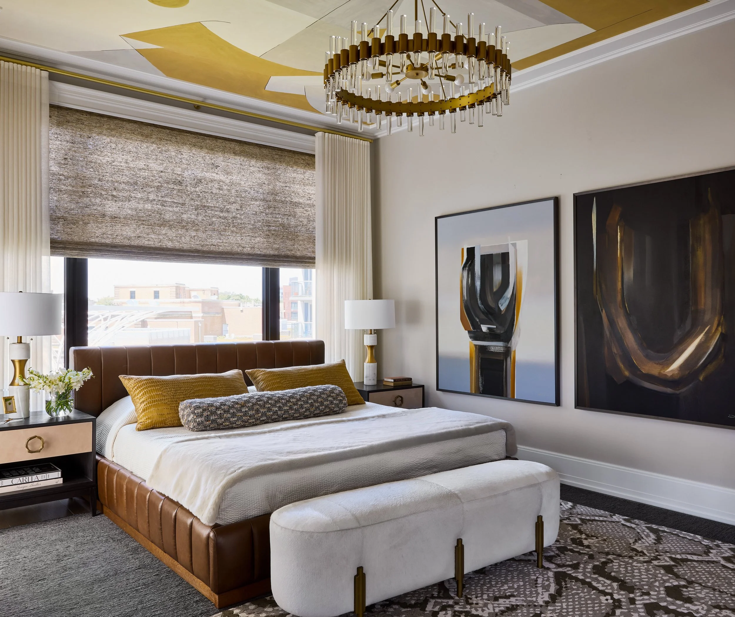 Luxury primary bedroom featuring bespoke artwork, elegant lighting, and sophisticated furnishings. Rich materials with a statement ceiling, designed by a luxury interior design firm based in Chicago and Denver.