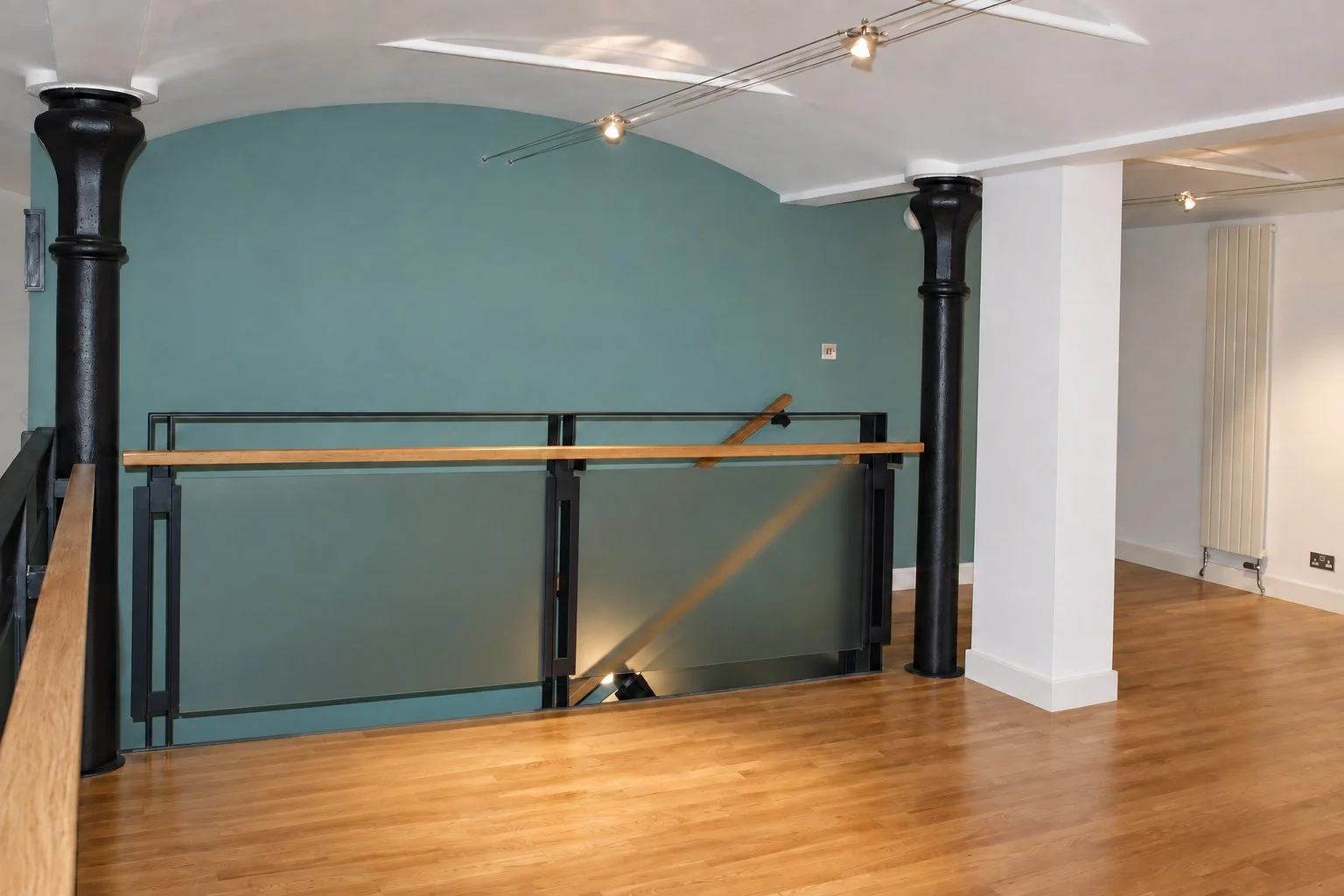 Completed Dundee engine room conversion with a glass mezzanine, bespoke staircase and retained cast-iron columns.