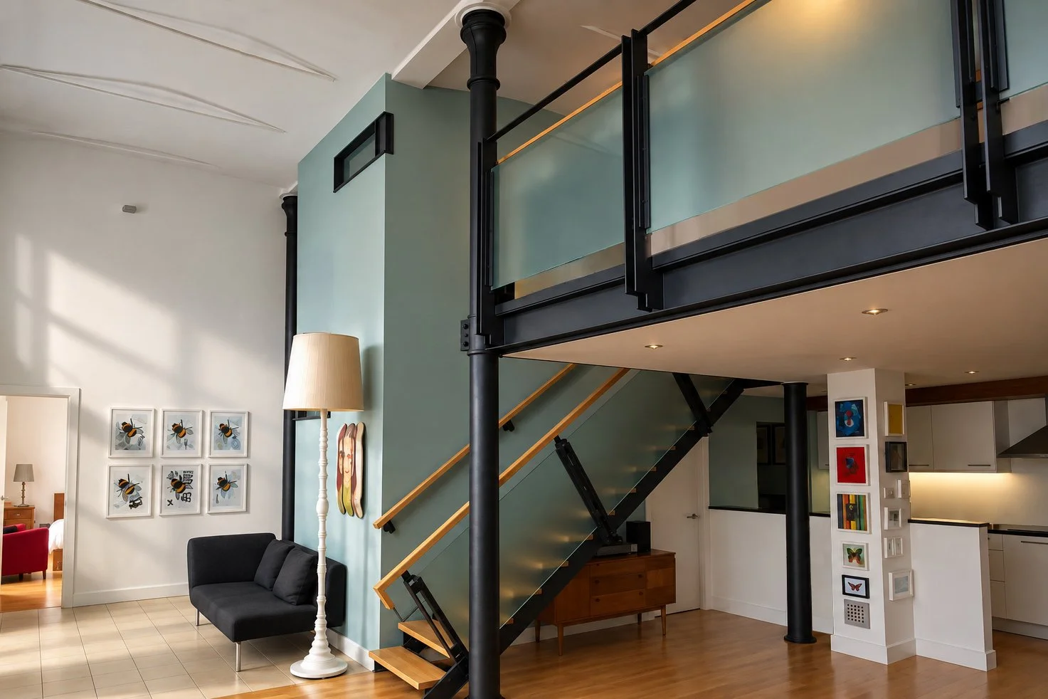 Converted former jute mill engine room in Dundee with a glass mezzanine, black steelwork and retained cast-iron columns.