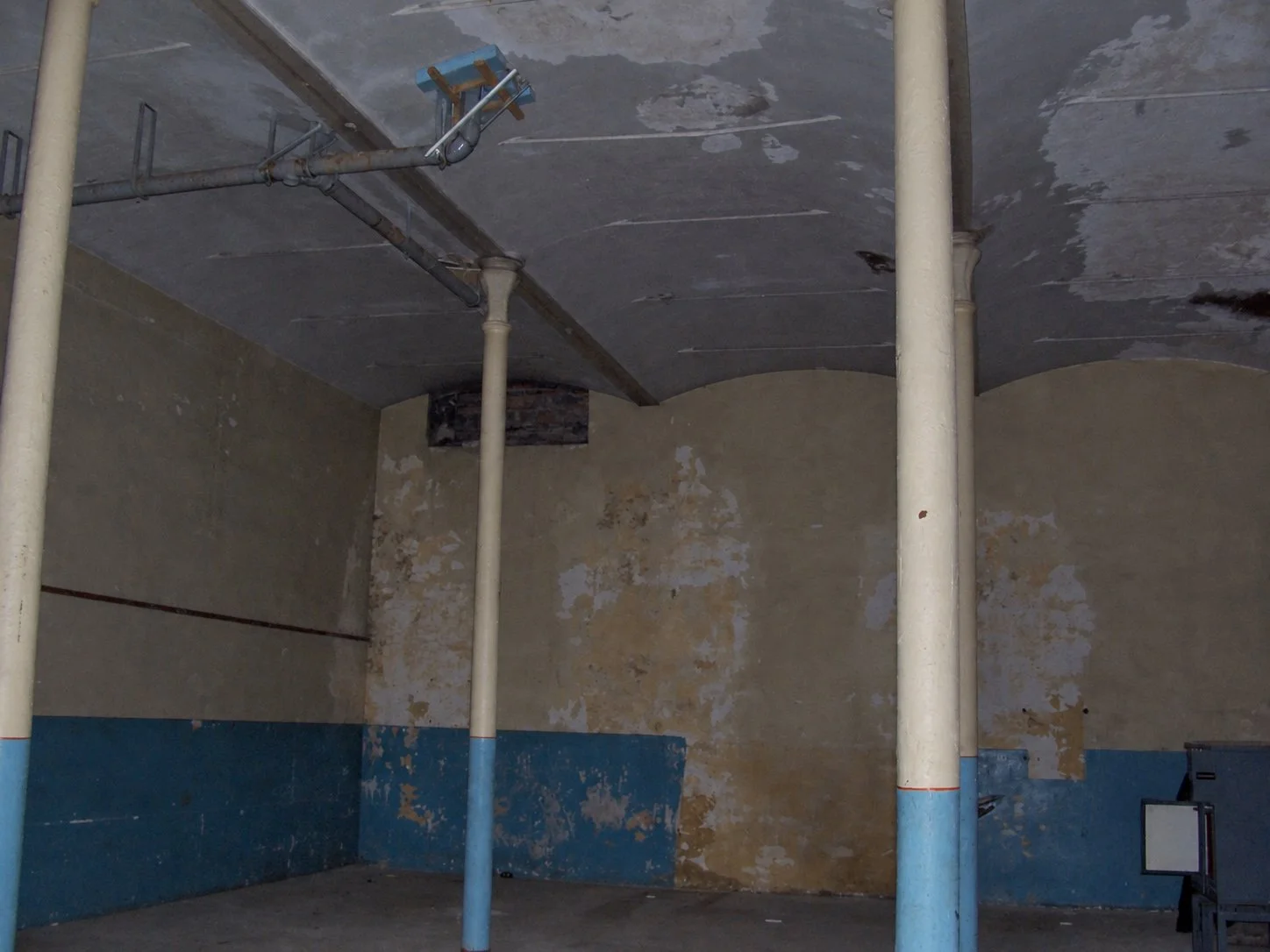 Former jute mill engine room in Dundee before conversion, showing the barrel-vaulted ceiling and original columns.