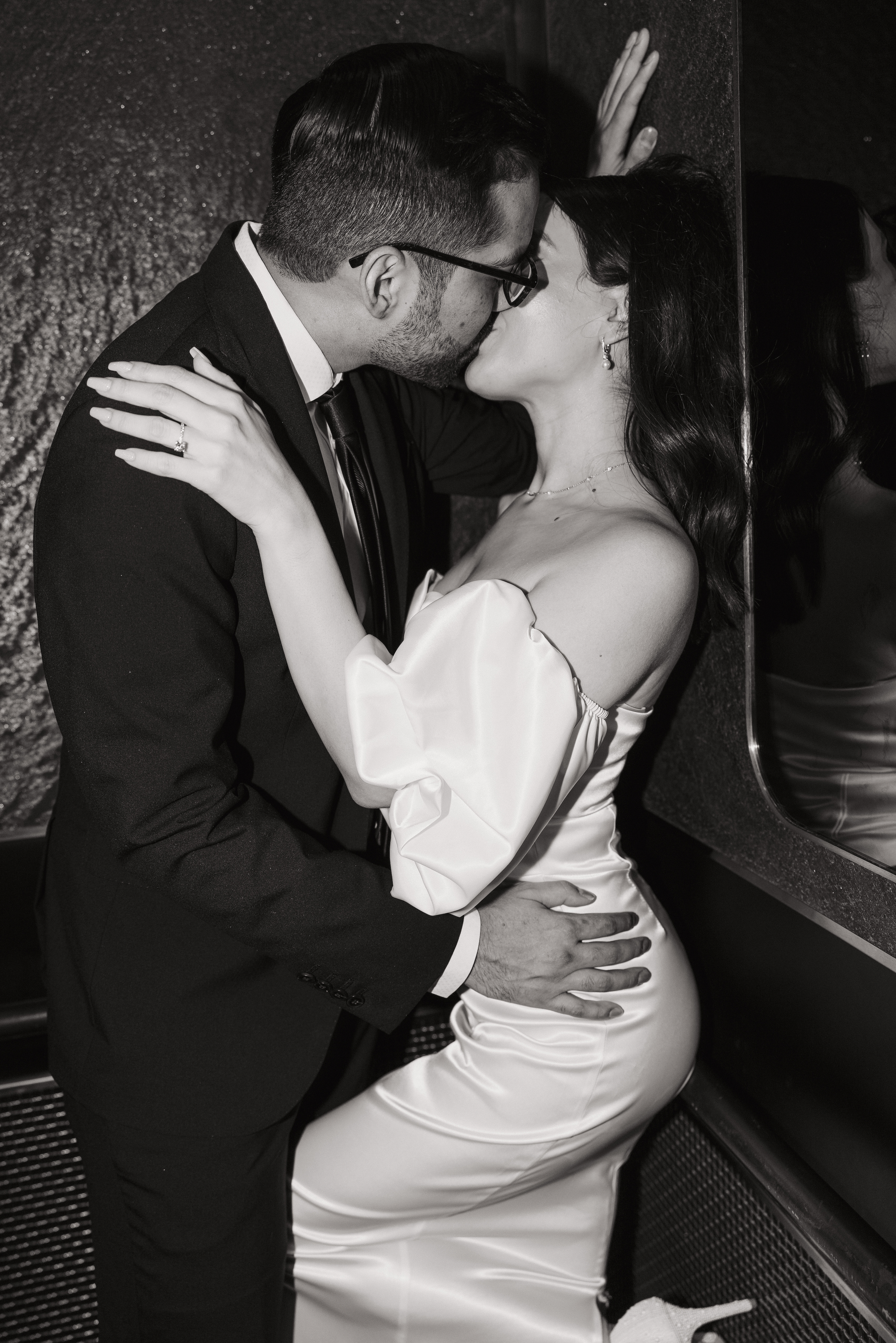 Couple kissing in black and white portrait at Thompson Hotel engagement session San Antonio.