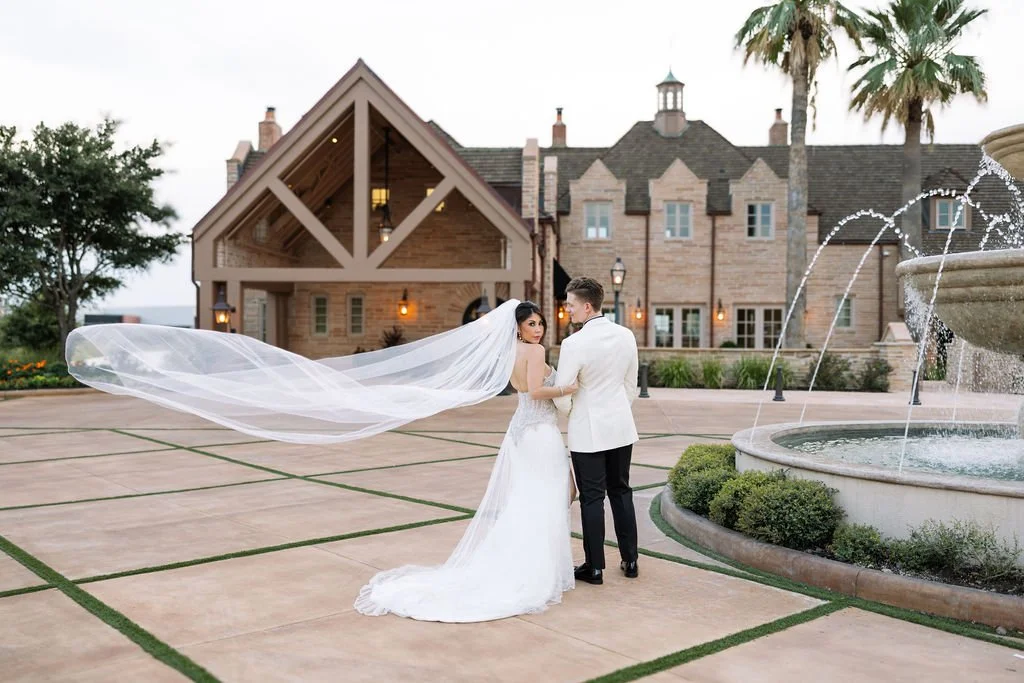 Bride and groom share a moment on the terrace of The Red Berry Estate, a stylish and romantic San Antonio wedding venue.