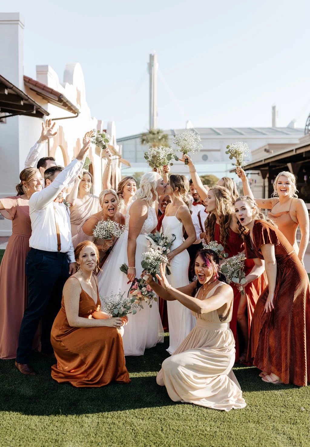 Joyful wedding party cheers on the lawn at The Espee, a downtown San Antonio venue with city views and plenty of personality.