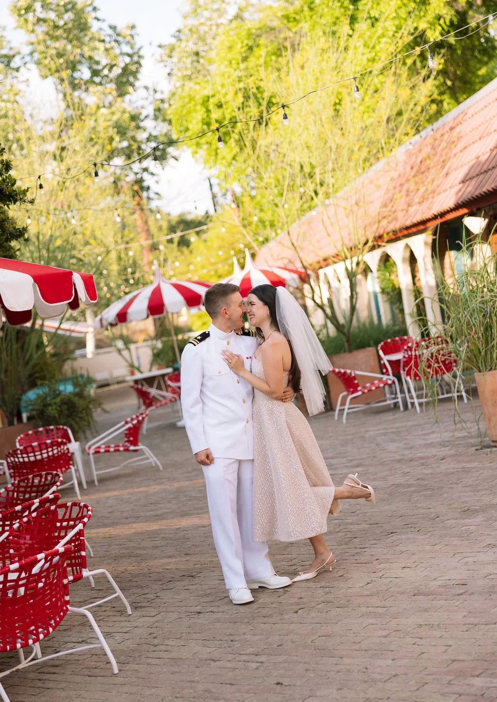 Angled shot of Stephanie and Mike kissing in Austin Motel's pool courtyard