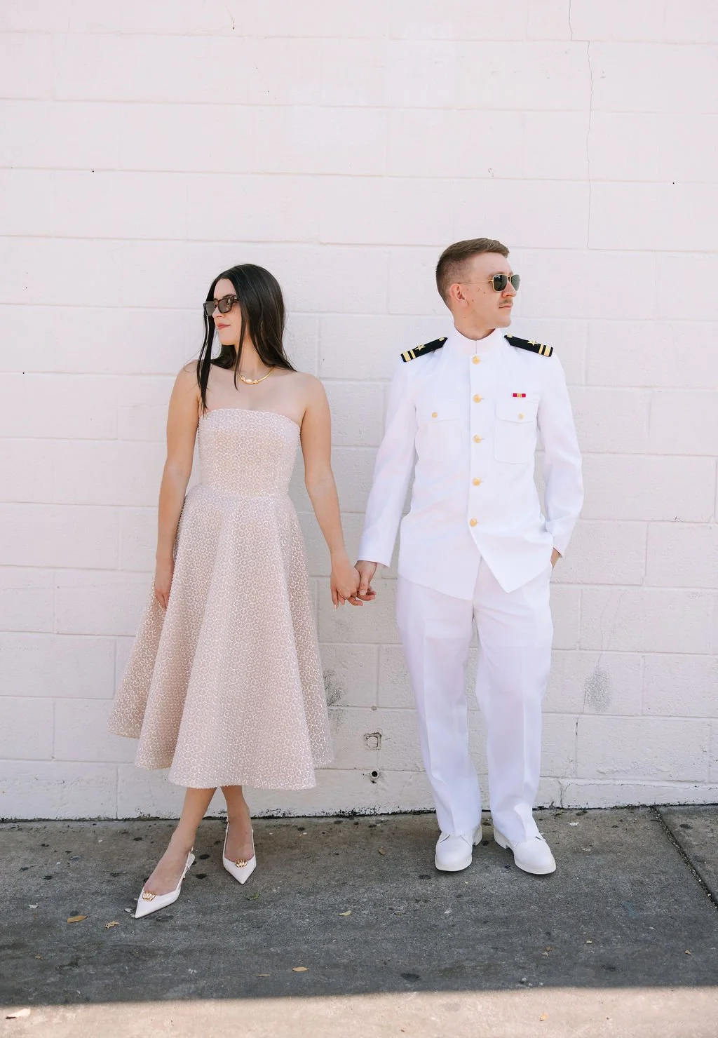 Editorial photo of Stephanie and Mike against a white brick wall on South Congress