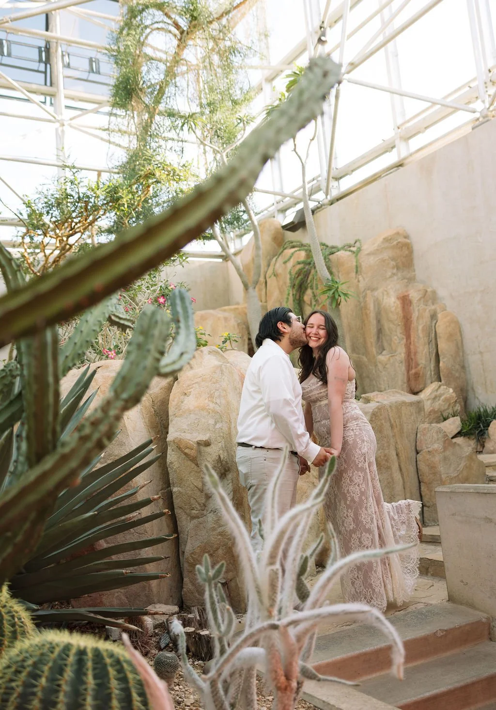 Couple standing among cacti at San Antonio Botanical Garden during engagement photos San Antonio.