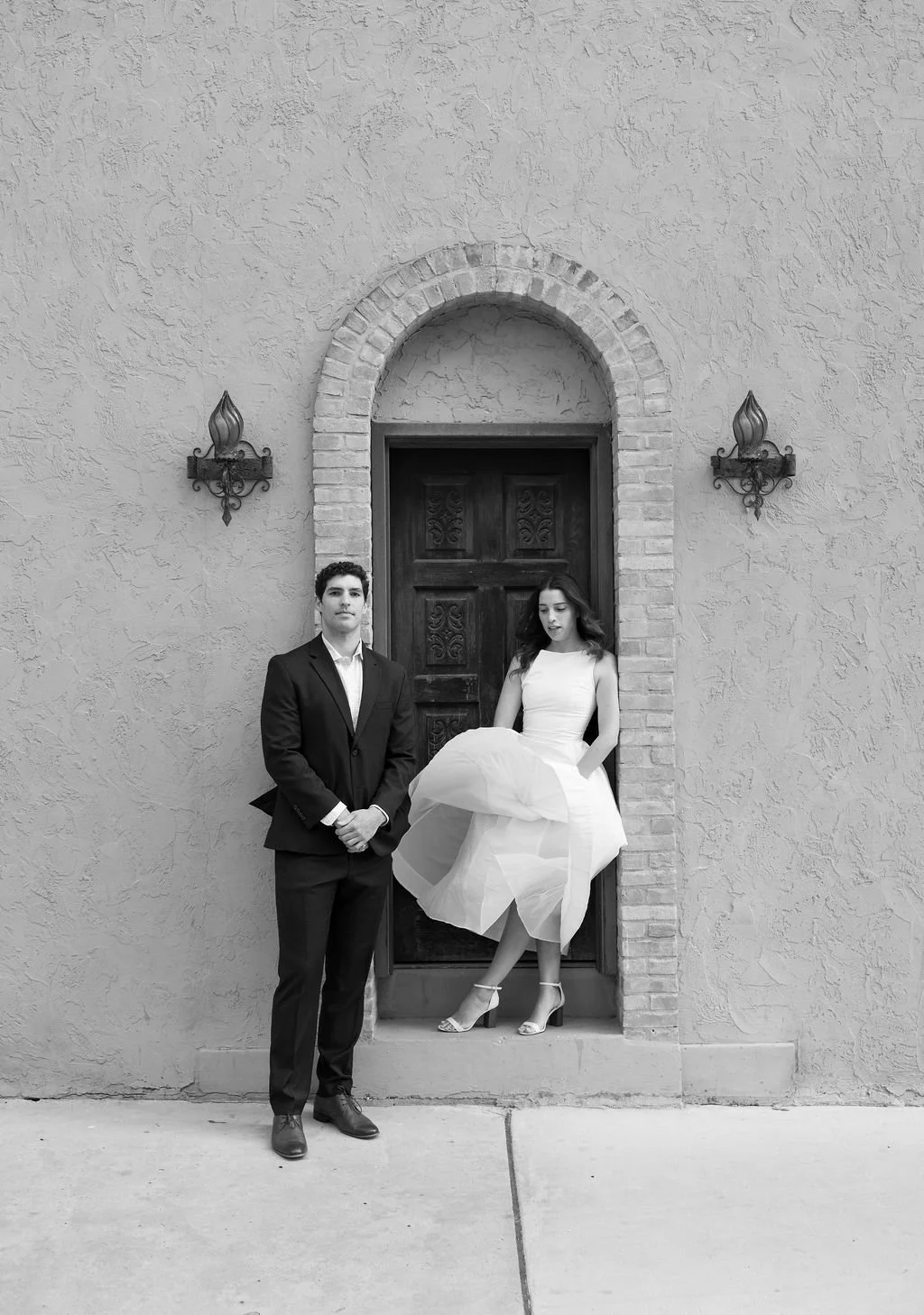 Couple standing in doorway during San Antonio engagement photos.