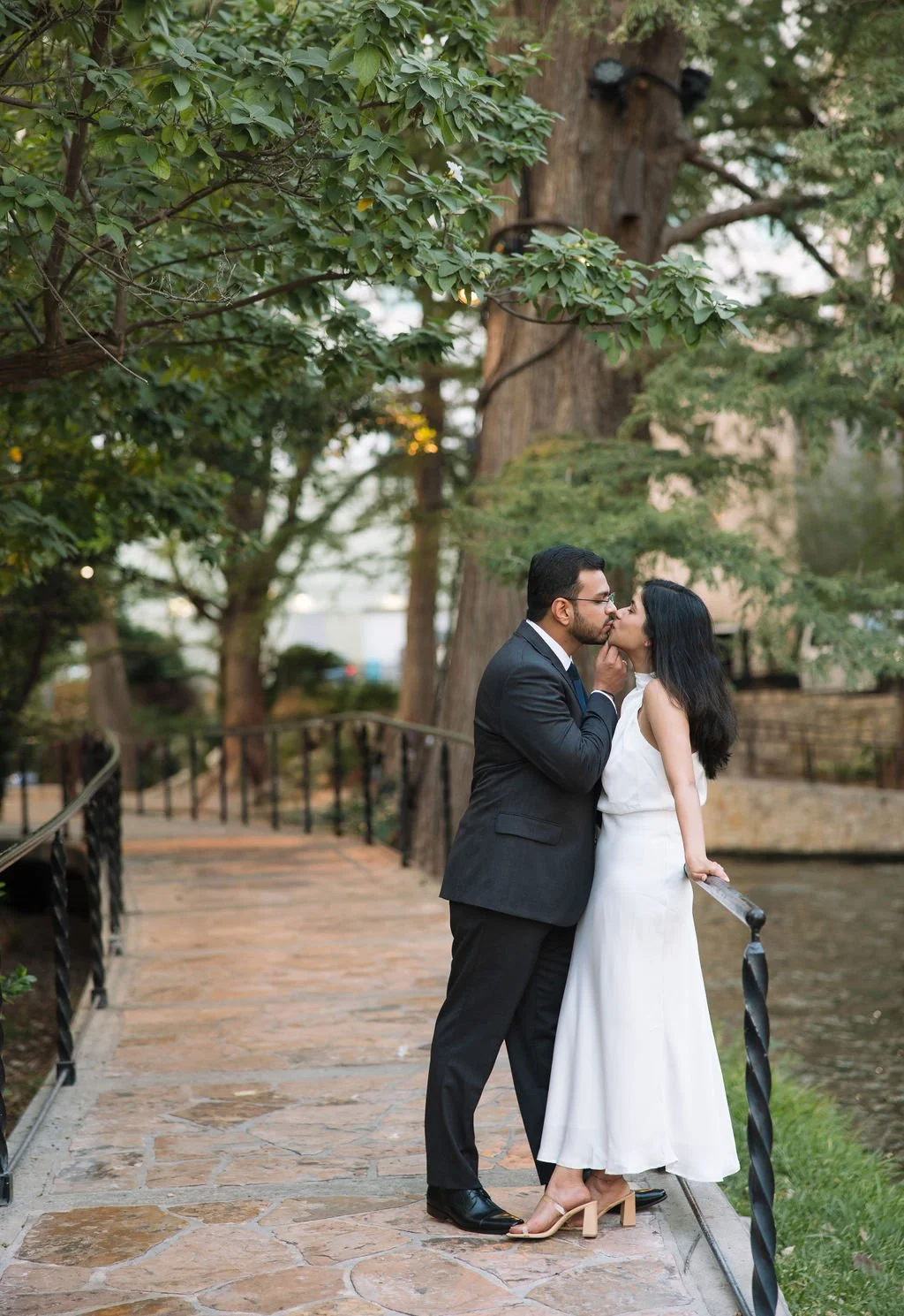 Couple kissing on stone pathway on the San Antonio River Walk