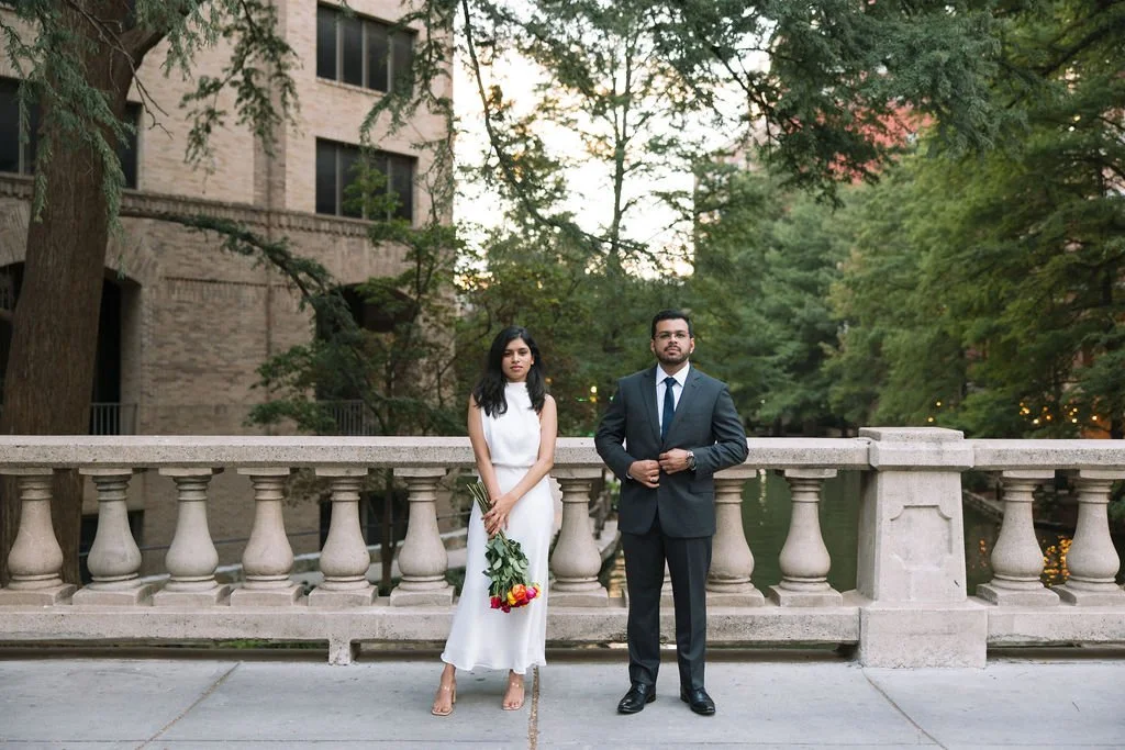 Couple holding hands on stone terrace overlooking river