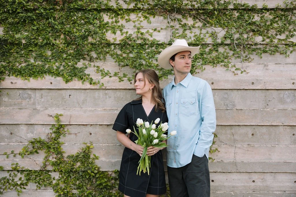 Couple standing in an editorial shot in front of an ivy-covered wall in the Pearl District downtown San Antonio