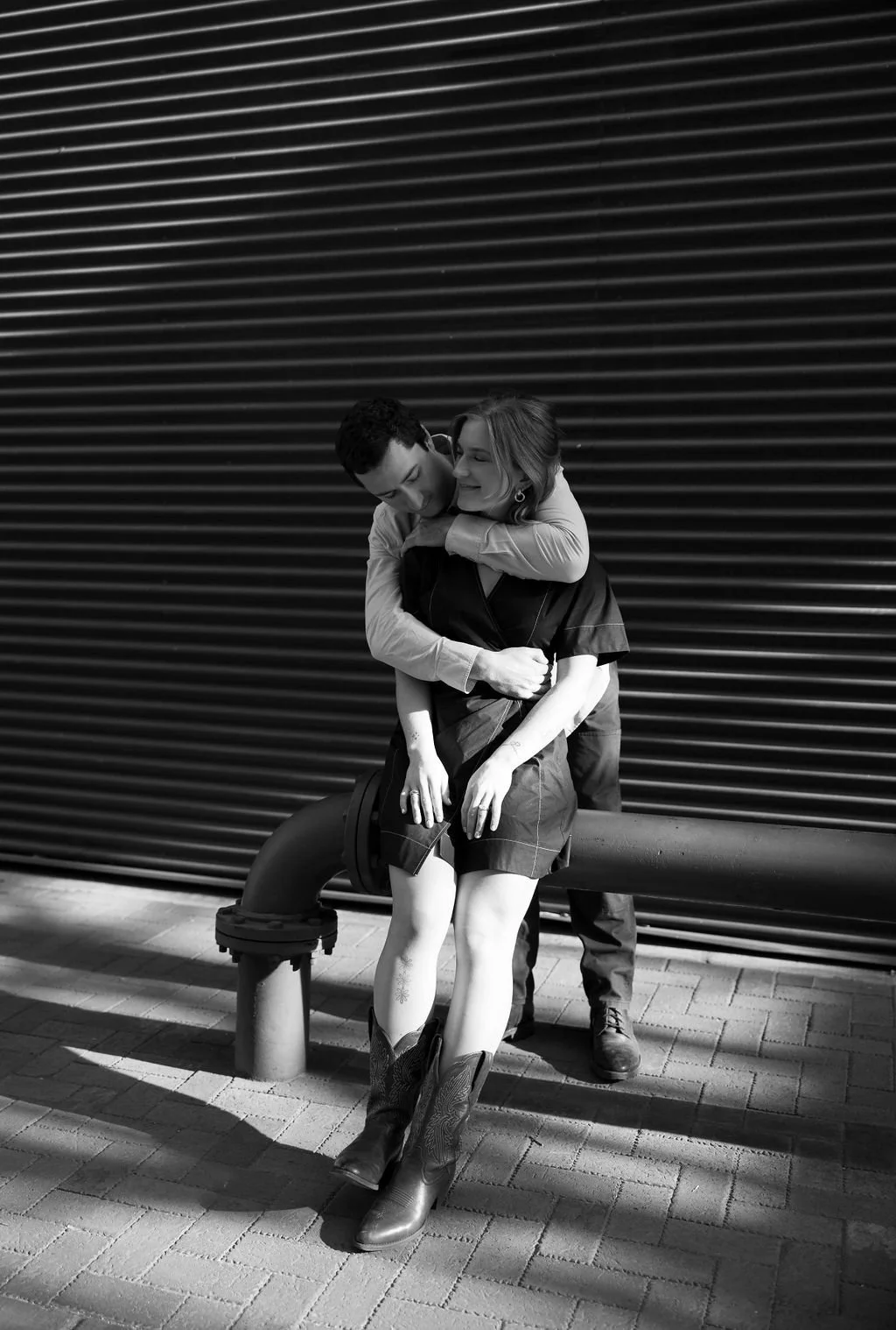 Couple cozying up in a moody modern shot at the Pearl