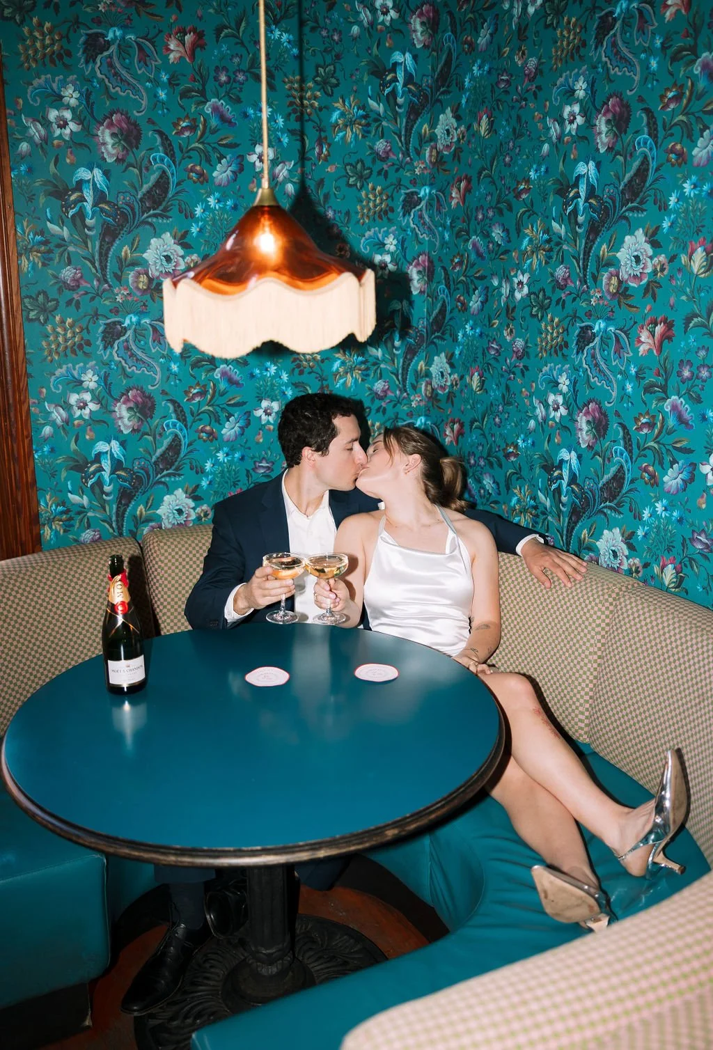 Couple lounging in a booth at the Best Quality Daughter Restaurant in the Pearl in downtown San Antonio