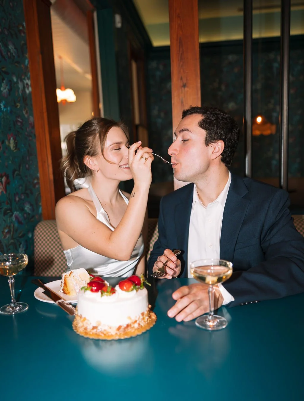 Couple sharing a strawberry cake at the Best Quality Daughter