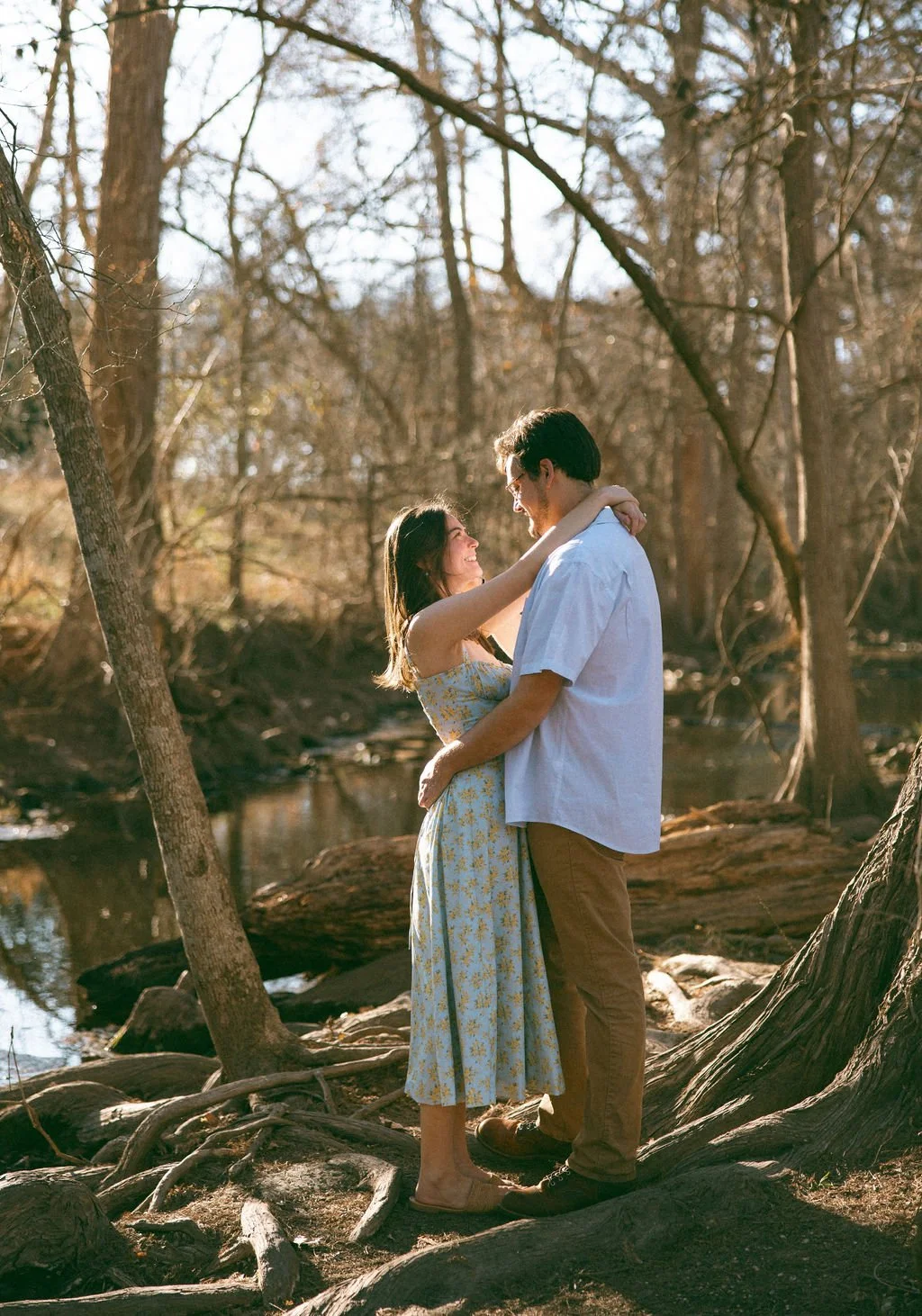 Couple embracing among trees at Cibolo Nature Center during engagement photos San Antonio.