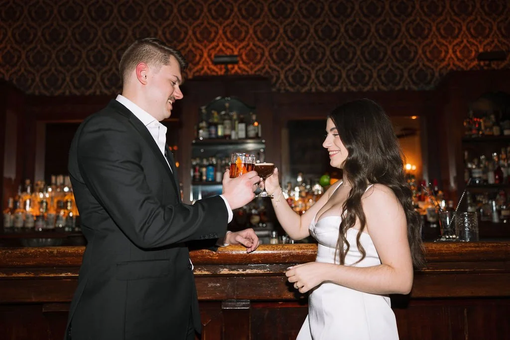 Couple cheersing at the Esquire Tavern speakeasy-esque bar