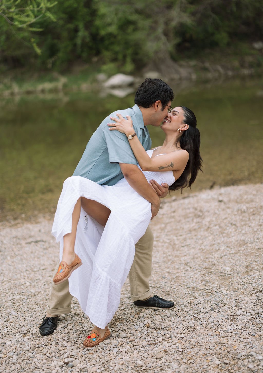 Couple dipping kiss by the riverbank during Guadalupe River State Park engagement photos San Antonio.