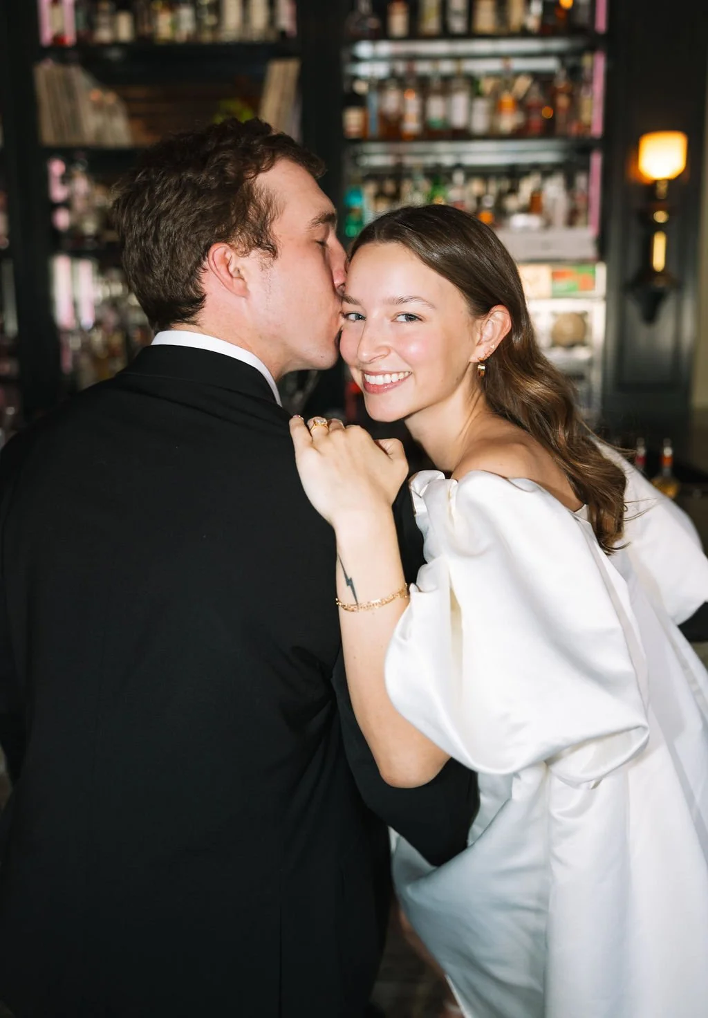 Couple cozying up together at the bar inside Barbaro during San Antonio engagement session.