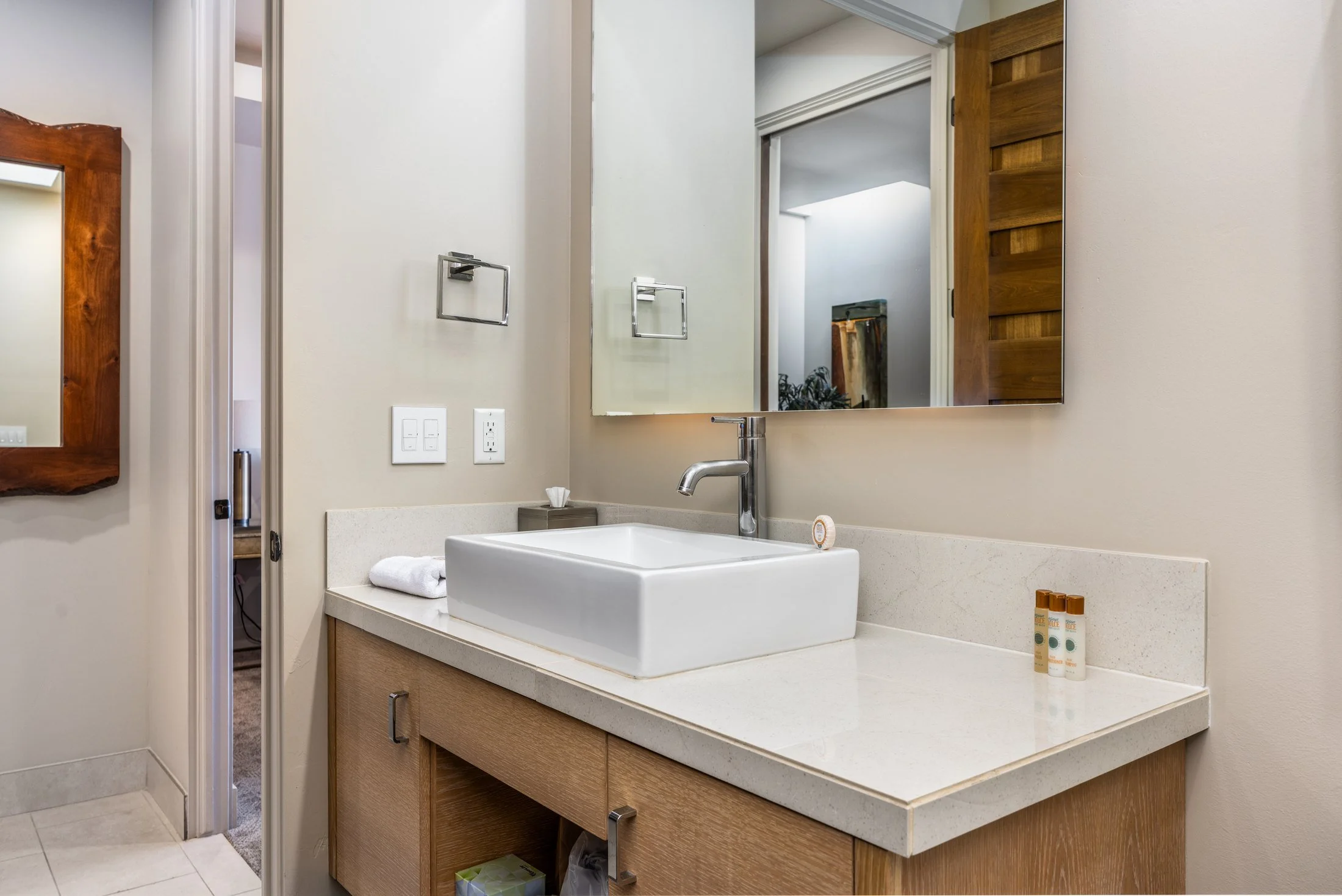 Guest bathroom with a vessel sink and wall mirror at The Inn at Entrada