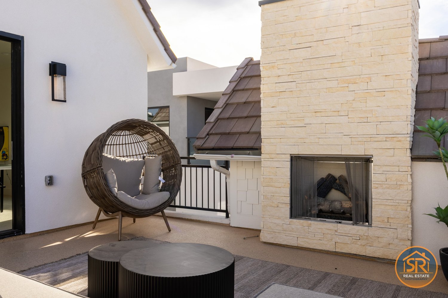 Rooftop lounge with a stone fireplace — from Sam Reed’s photography portfolio