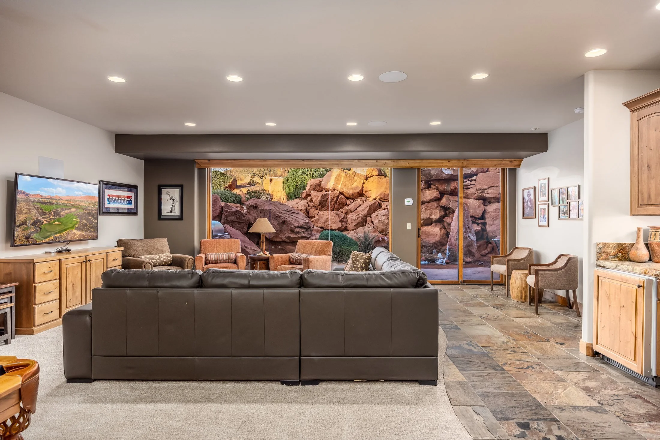 Spacious living room opening toward a red-rock patio at The Inn at Entrada