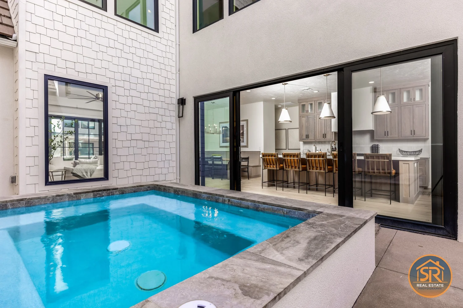 Courtyard pool beside an open living area — from Sam Reed’s photography portfolio