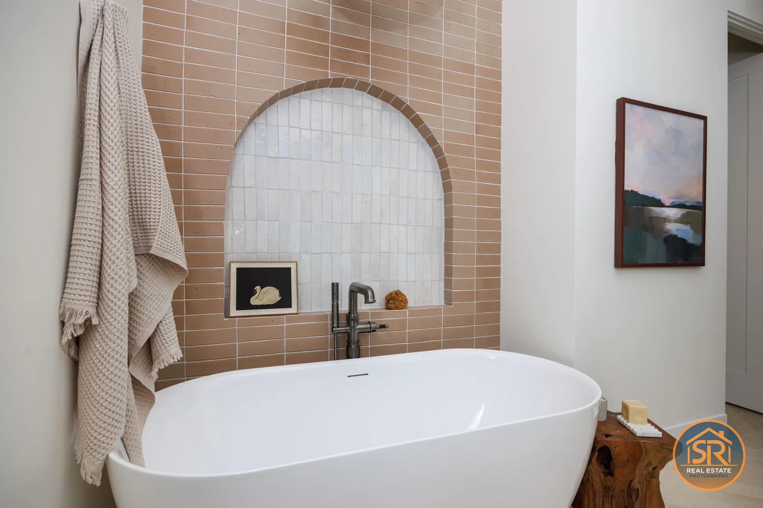 Freestanding bathtub beneath an arched niche — from Sam Reed’s photography portfolio