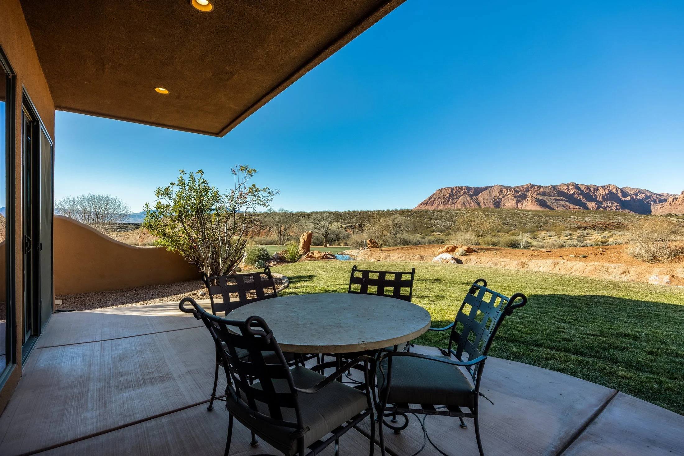 Covered patio with outdoor dining and mountain views at The Inn at Entrada