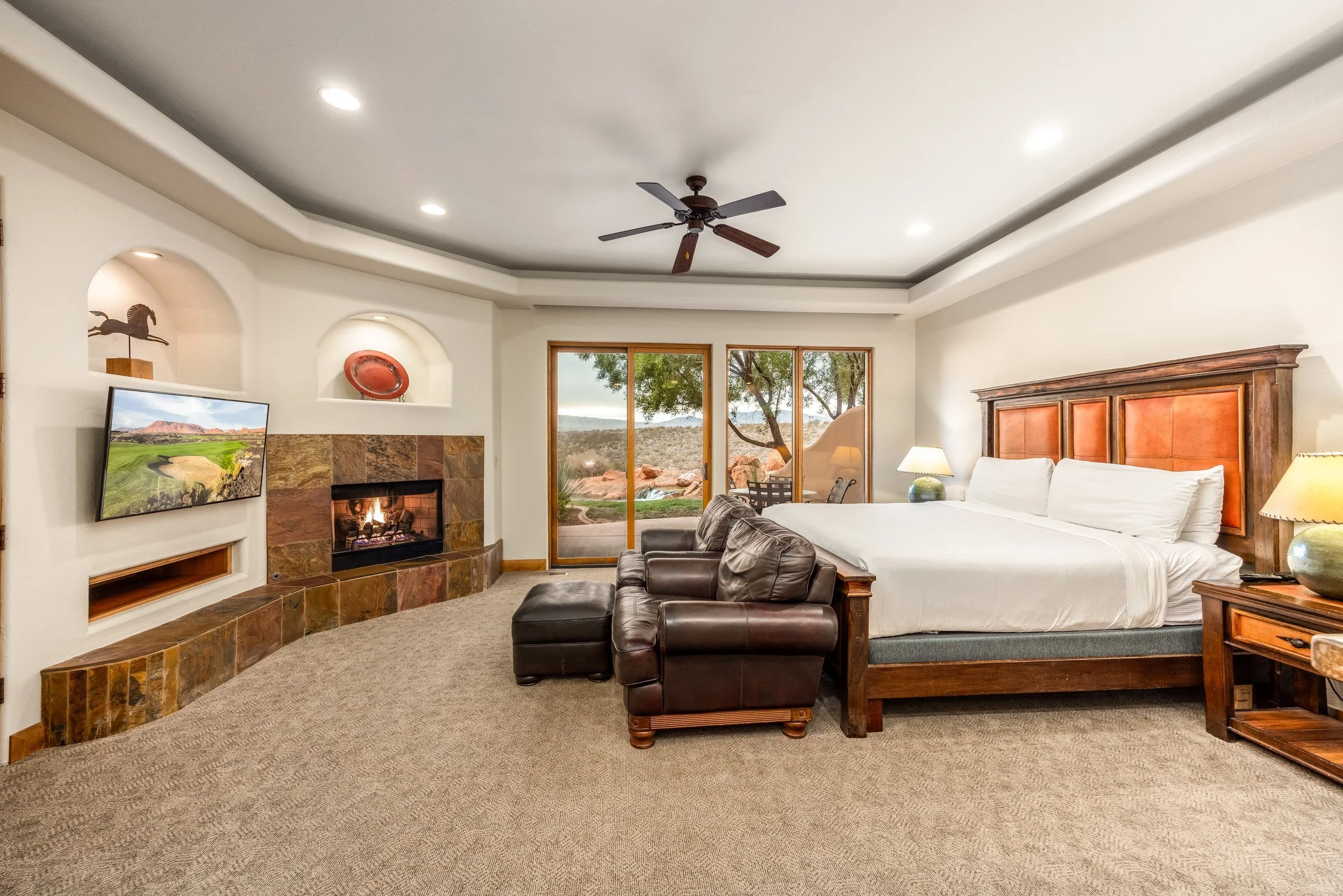 Guest suite with a fireplace, seating area and desert views at The Inn at Entrada