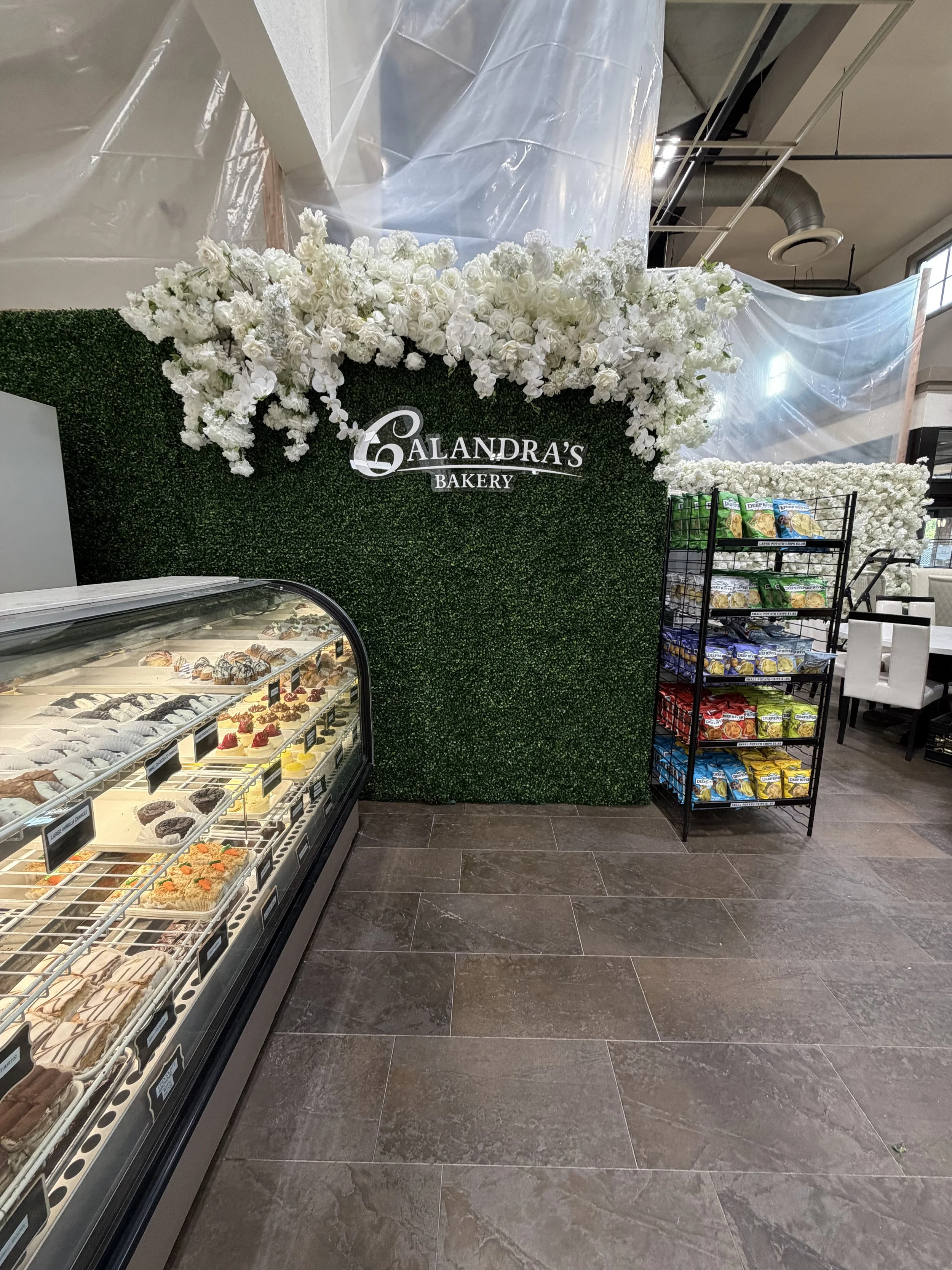 Boxwood and white flower wall for an in-store display
