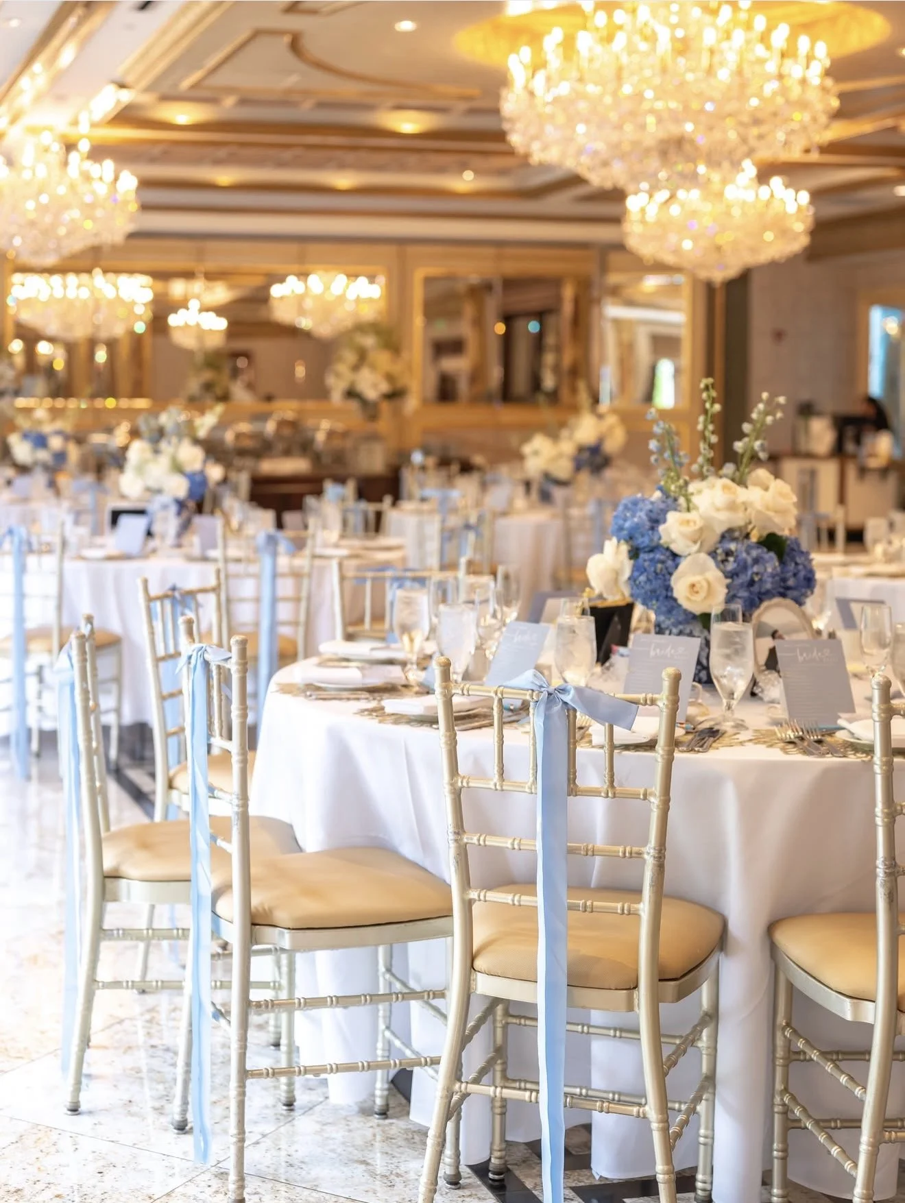 Reception ballroom dressed in blue and white florals, by Blooms by Lily