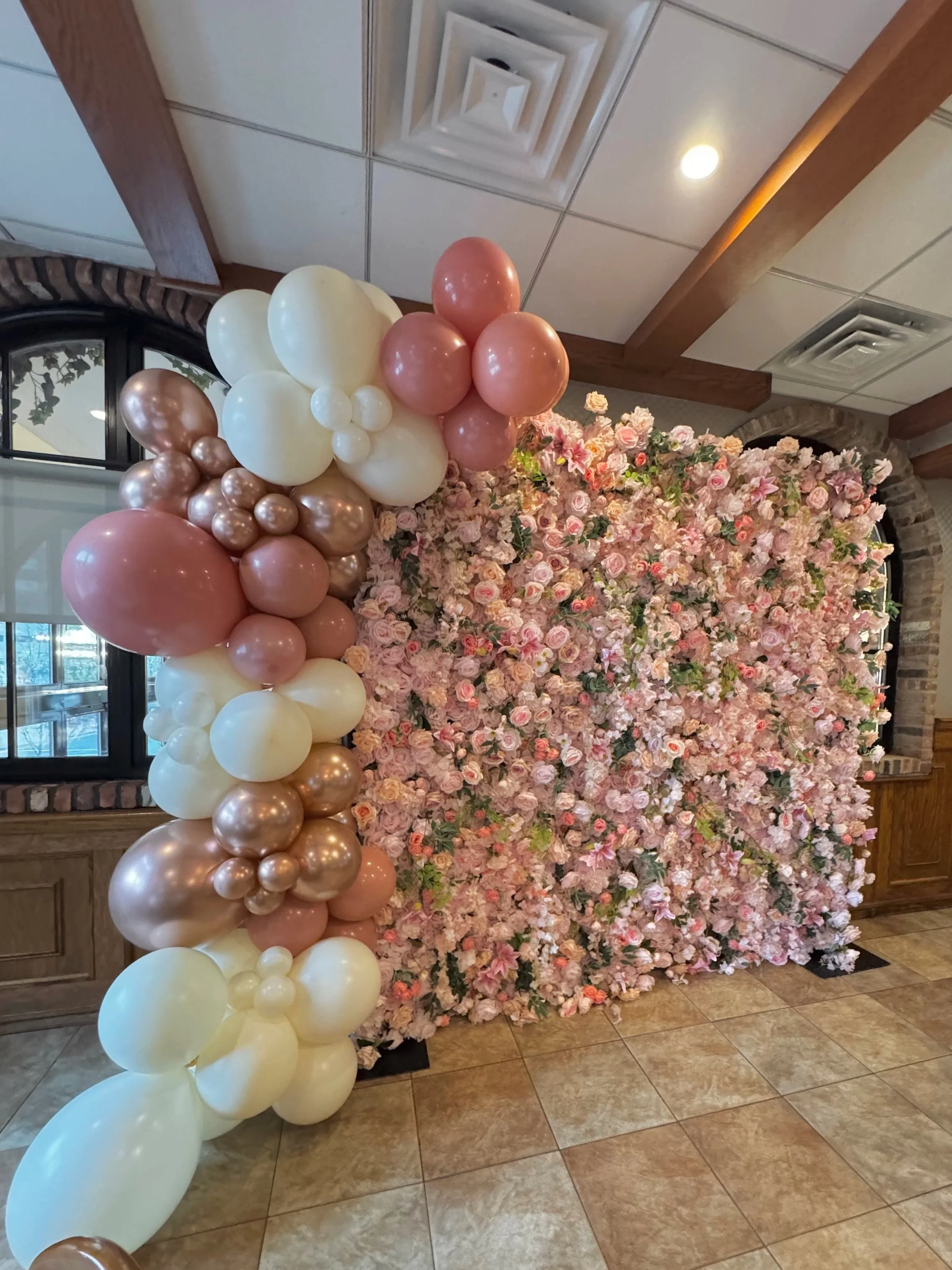 Pink and white flower wall with a balloon garland in blush and white, by Blooms by Lily
