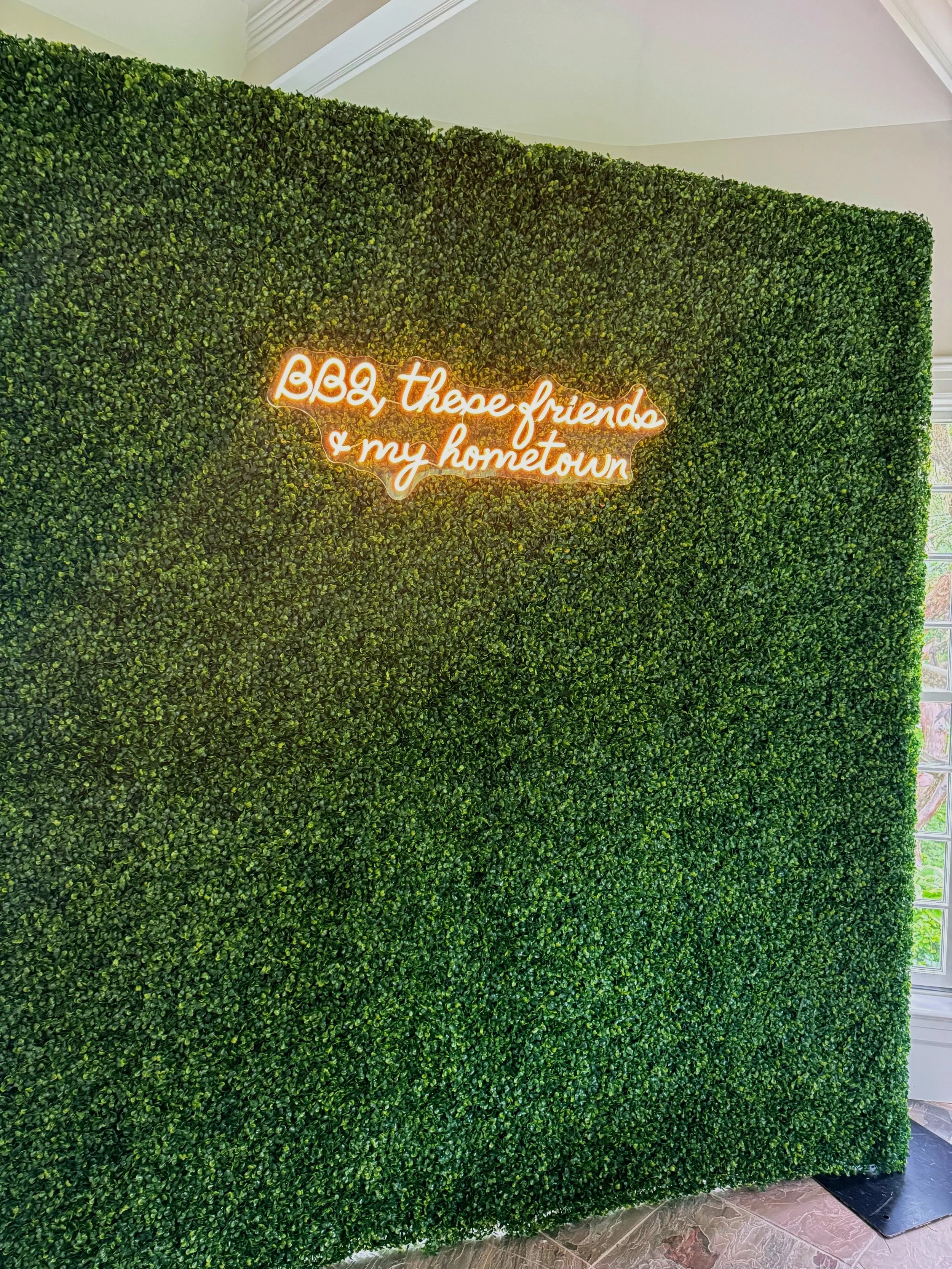 Eli green boxwood wall with a custom neon sign, by Blooms by Lily