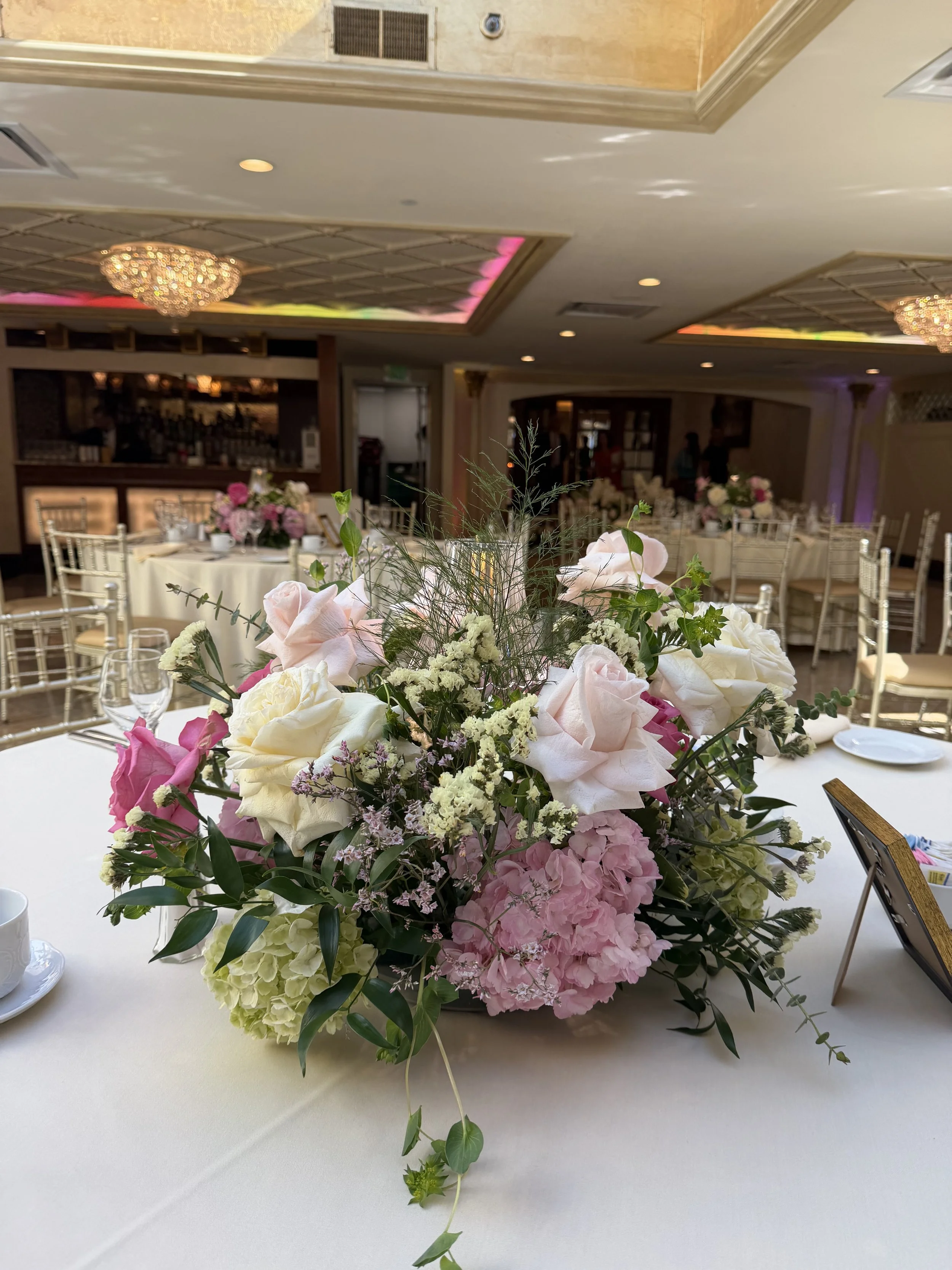 A pink and white fresh centerpiece for a bridal shower at Seasons in Washington Township, NJ, by Blooms by Lily.