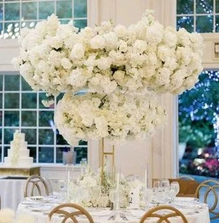 Tall white centerpiece in a bright reception room, by Blooms by Lily