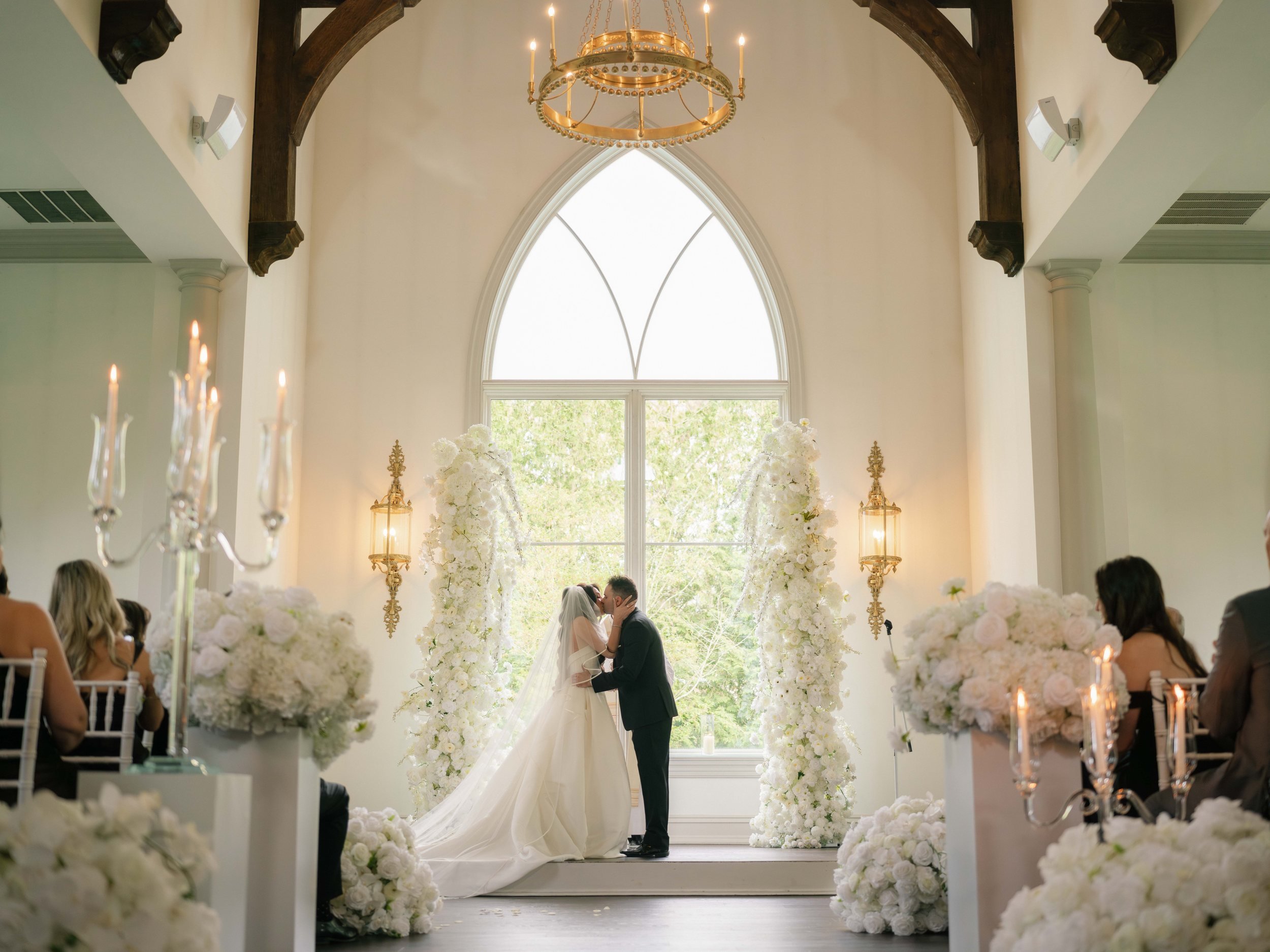 Silk white rose floral columns and aisle florals at a Park Château wedding ceremony, showing the full, lush look of Blooms by Lily silk florals