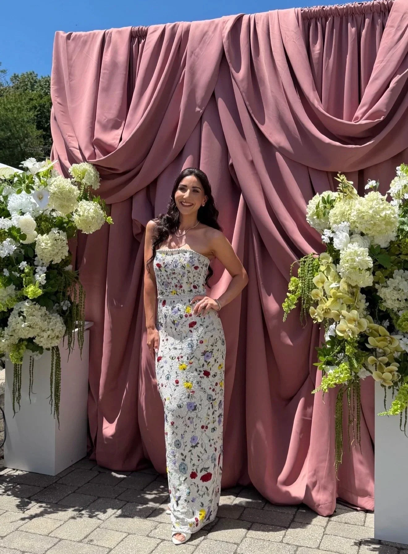 Draping: a dusty rose backdrop framed with white hydrangeas, soft and romantic for her photo moment.