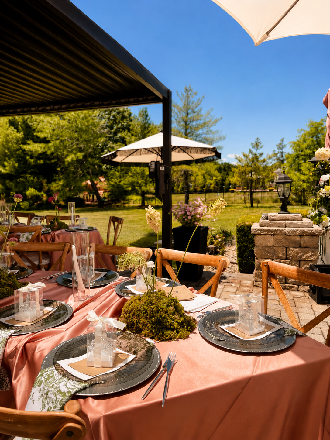 Backyard bridal shower tables with terracotta linens and moss centerpieces under white umbrellas in New Jersey, by Blooms by Lily