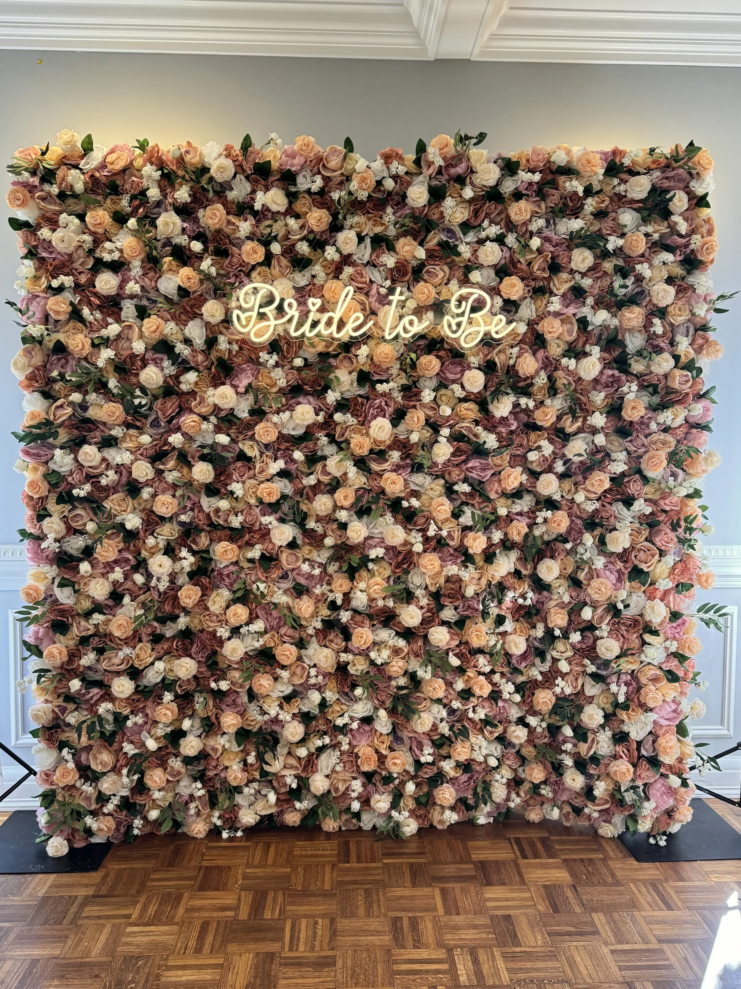Ane earth-tone flower wall with a Bride to Be neon sign, by Blooms by Lily