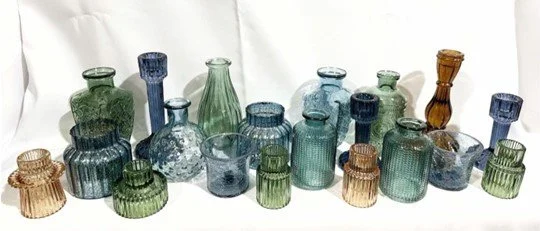 Assorted color small glass vases, tea light holders, and taper candle holders. Qty 20 total.