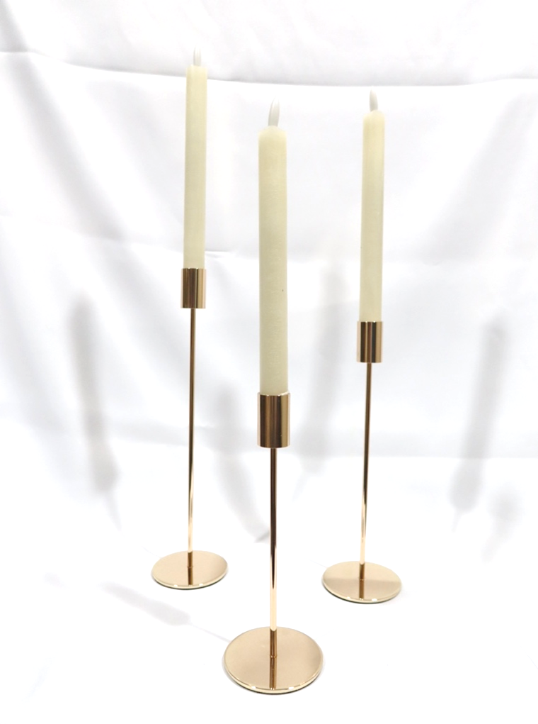 Gold Candlesticks. Qty 12 each size (S, M, L). Flameless flickering tapers, qty 32 (each taper requires 2 AAA batteries, NOT supplied by Venue).