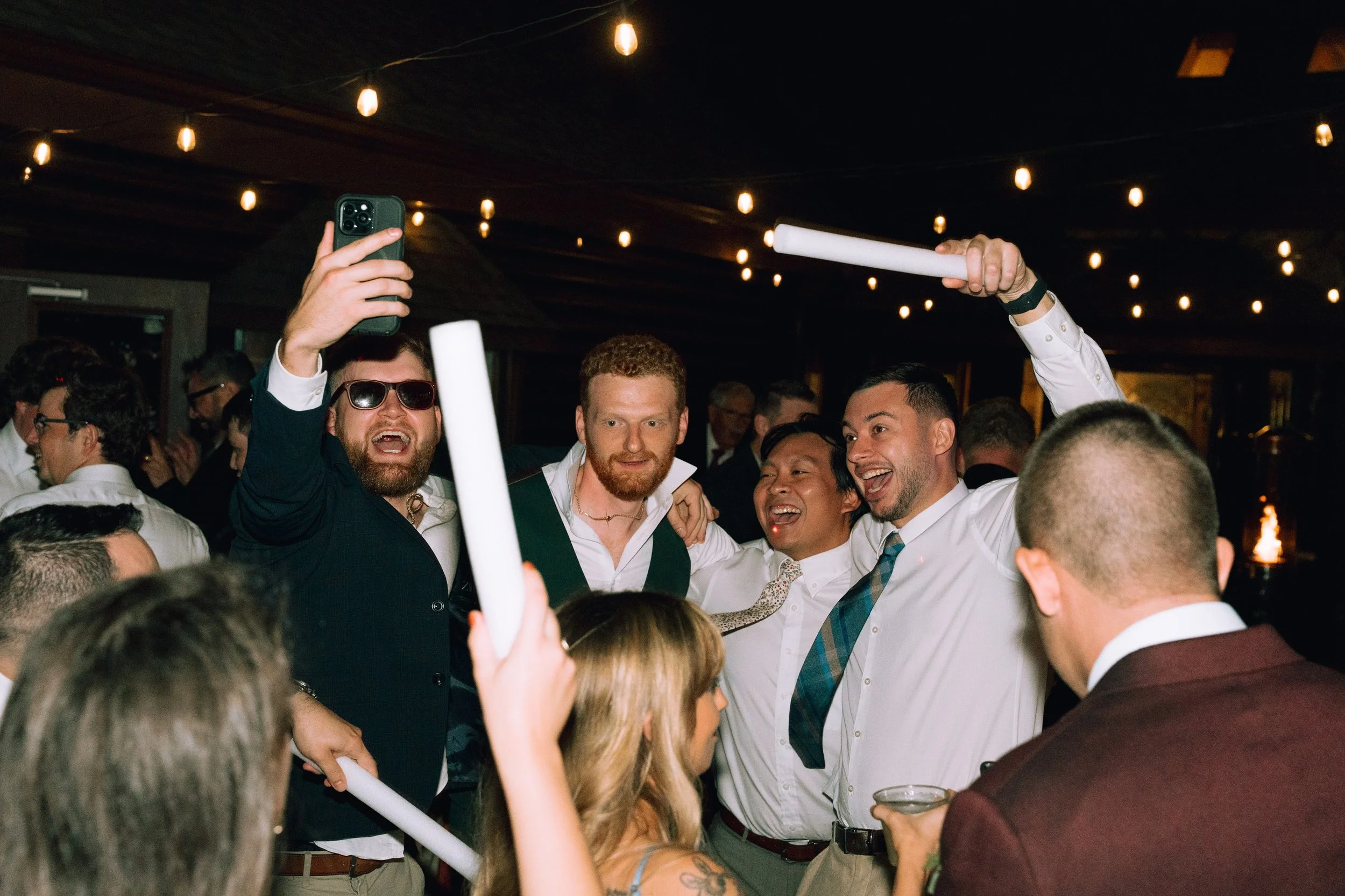 Reception taking place outside venue with music and wedding party.