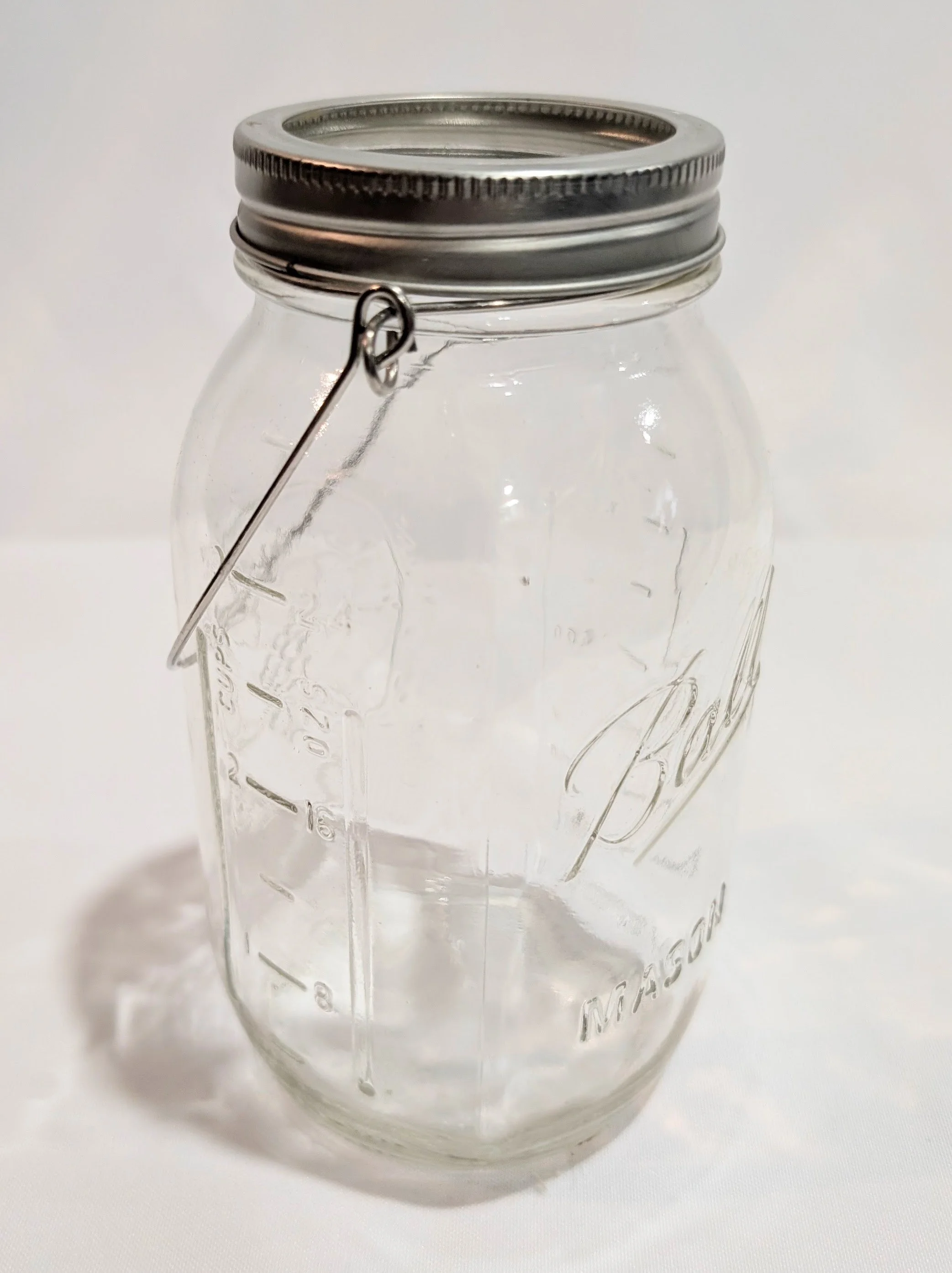 Mason jars with ring and some with metal handle. Qty 16
