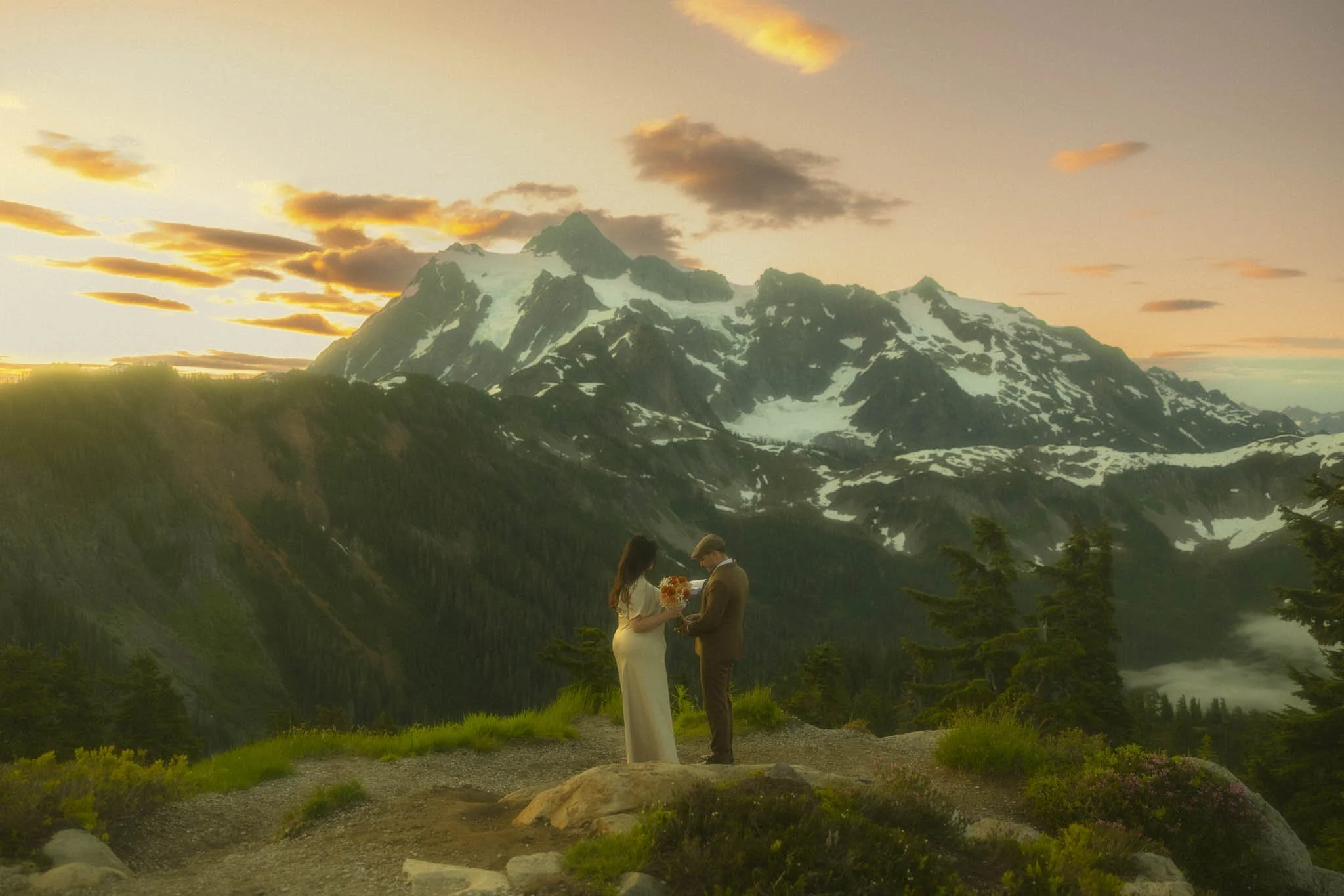a couple saying their vows on a hiking trail in Mt Baker at sunrise
