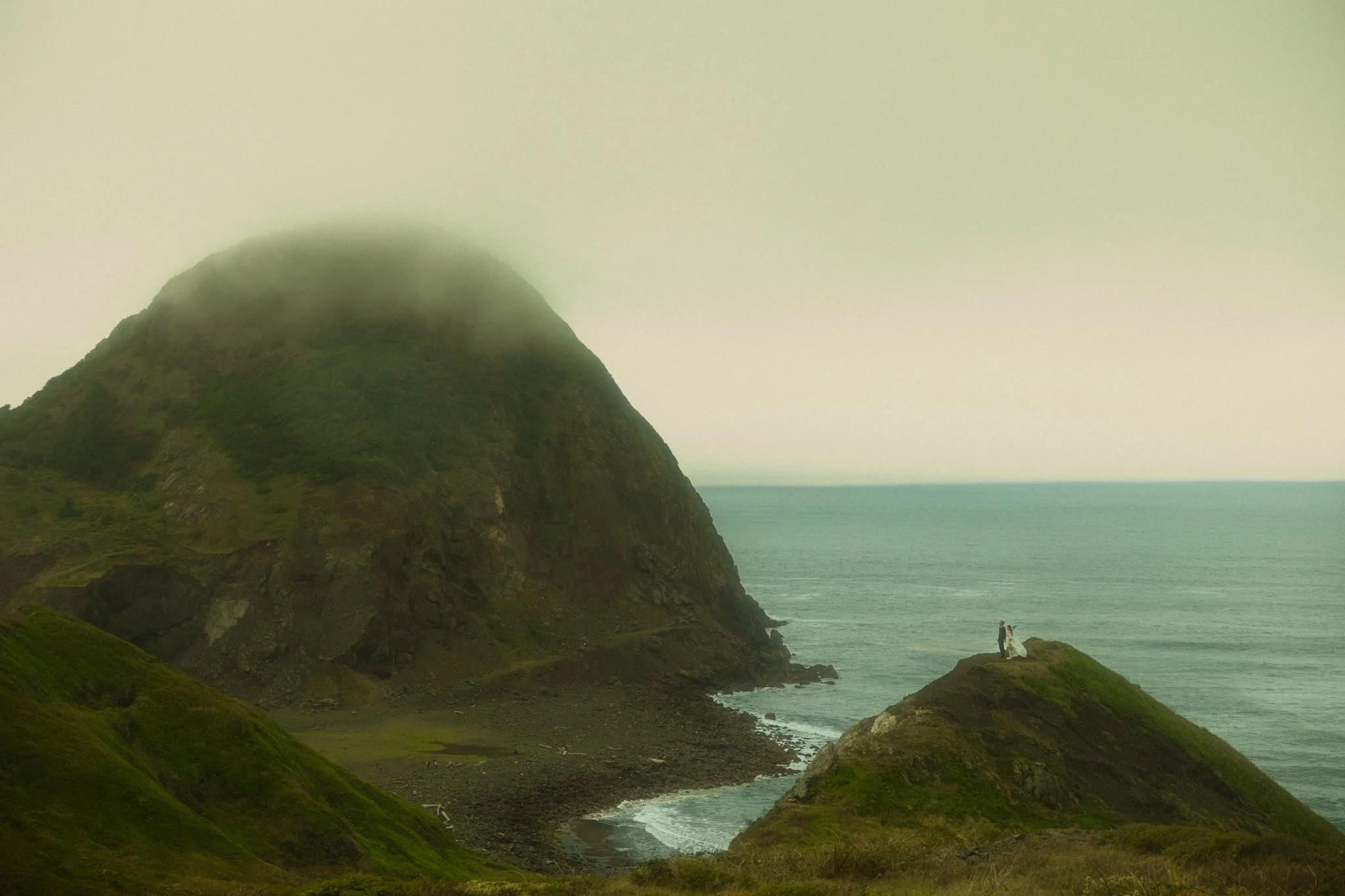 a couple getting married along the moody Oregon Coast