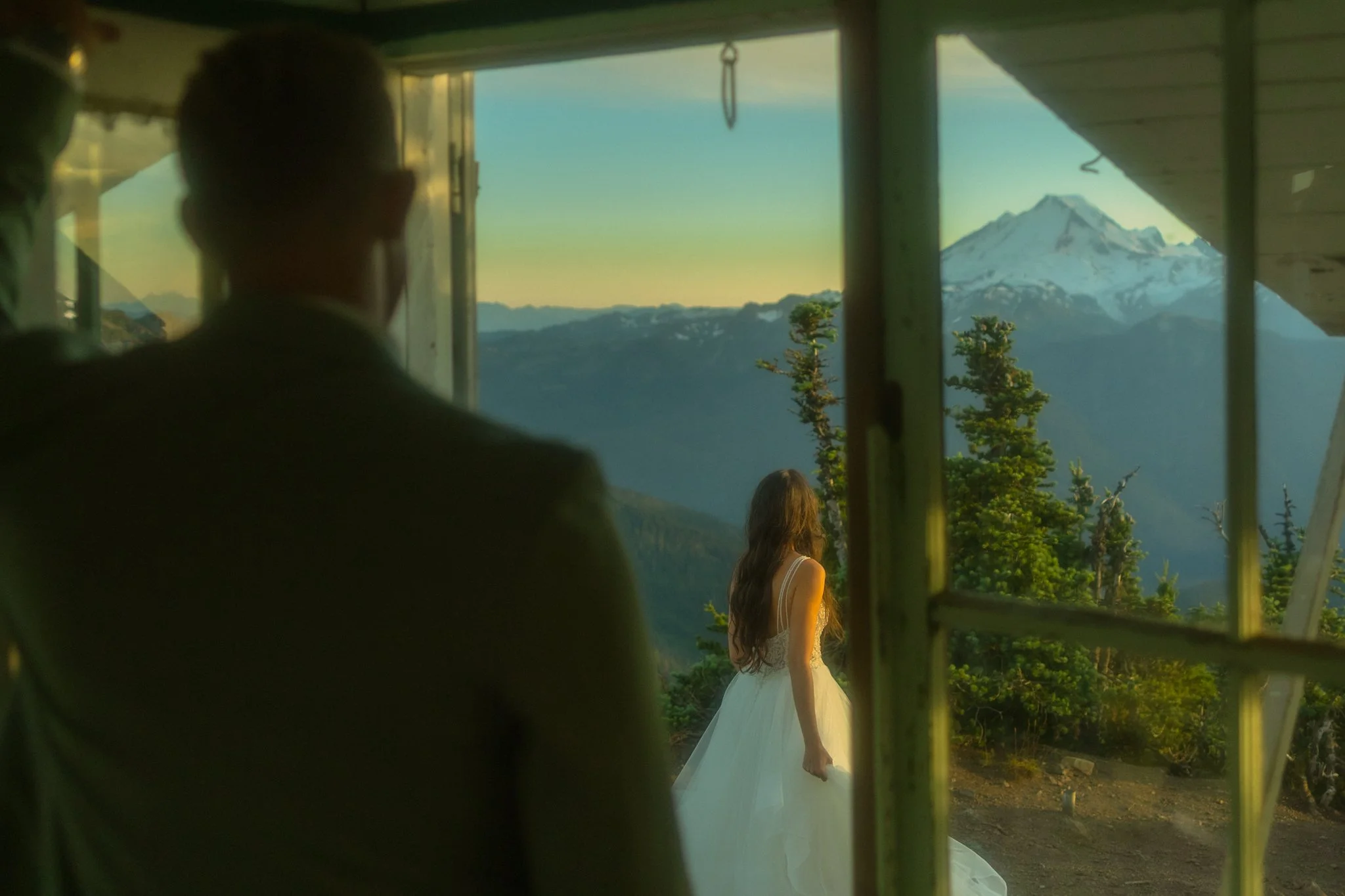 an elopement couple admiring the mountains from a fire lookout in the North Cascades