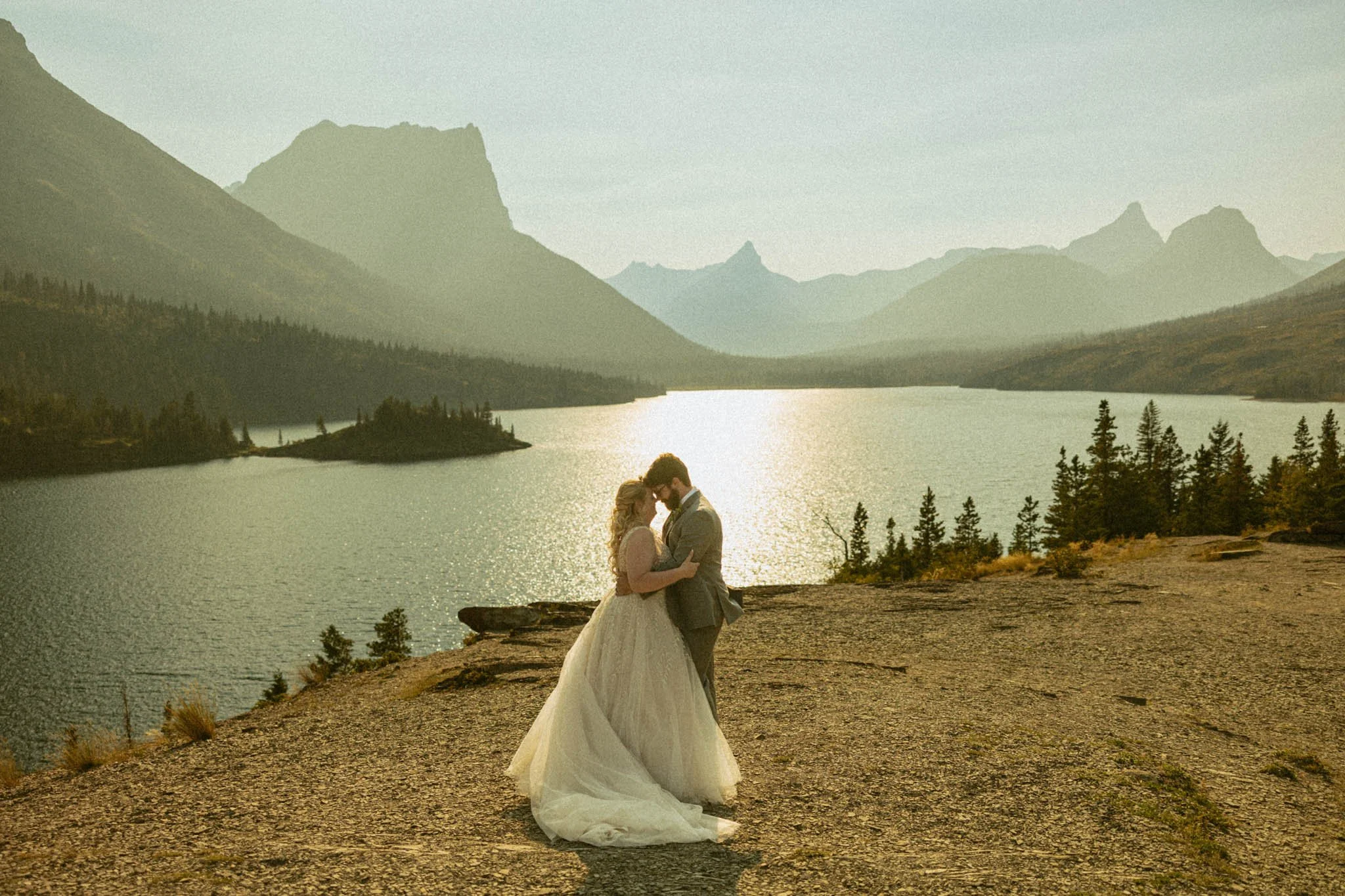 an elopement couple embracing at Sun Point in Glacier National Park