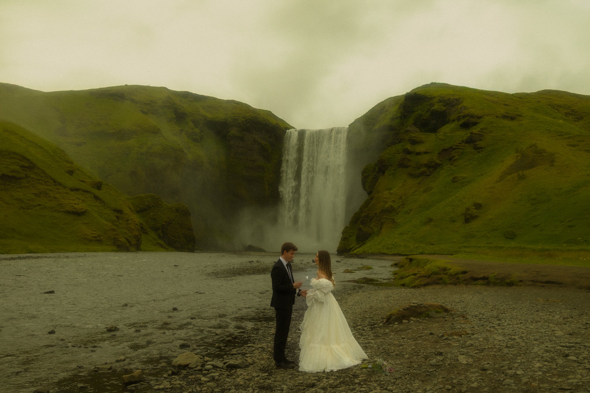 a couple sharing their vows at Skogafoss in Iceland